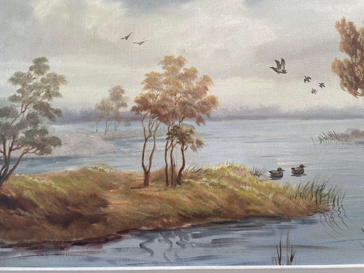 Beautiful large French oil on canvas landscape of a peaceful river scene featuring ducks and trees in a ornate gold frame. Sourced from France and in good original condition.
