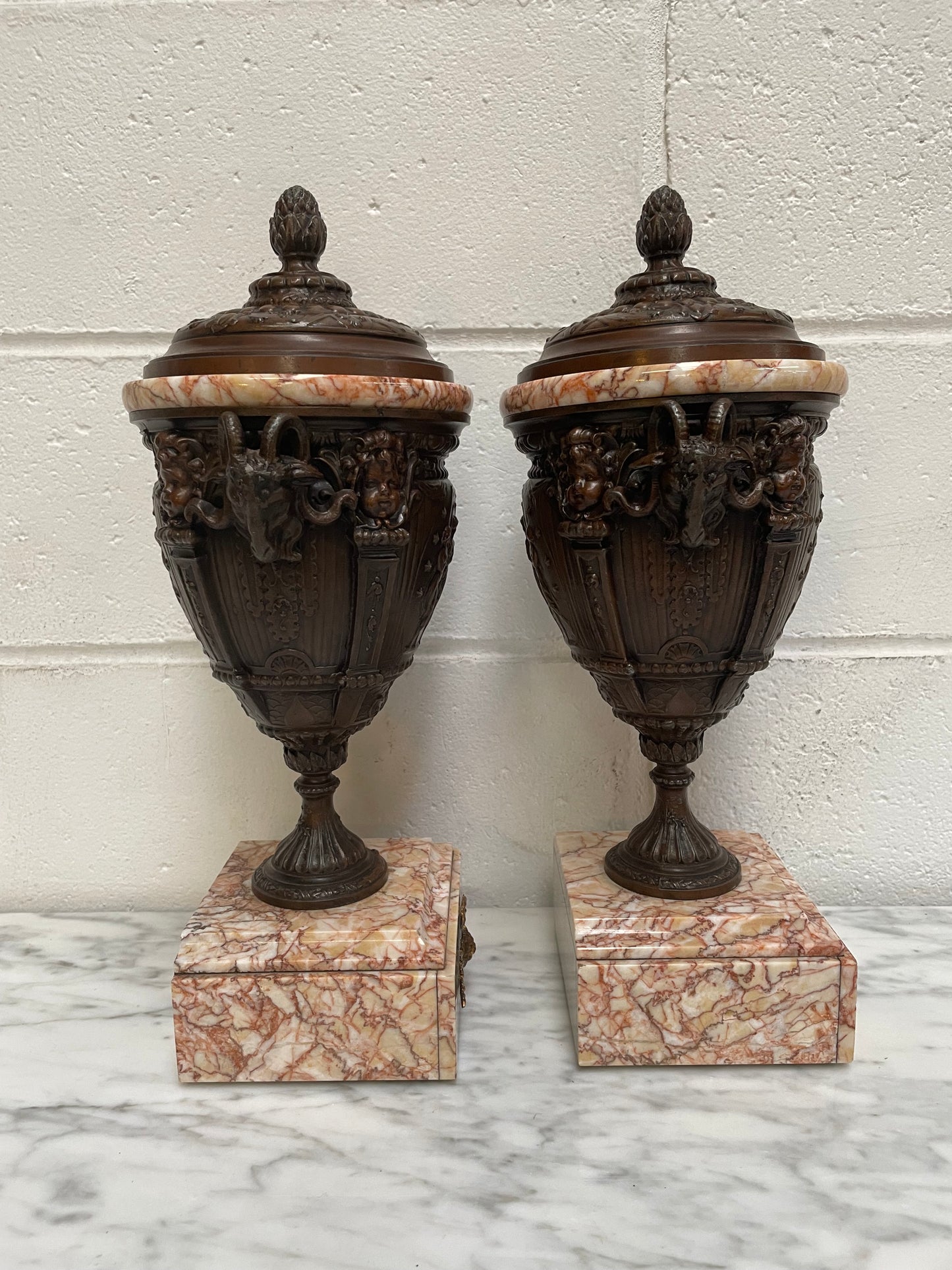 Pair of French Bronzed Spelter Urns on a Marble Base