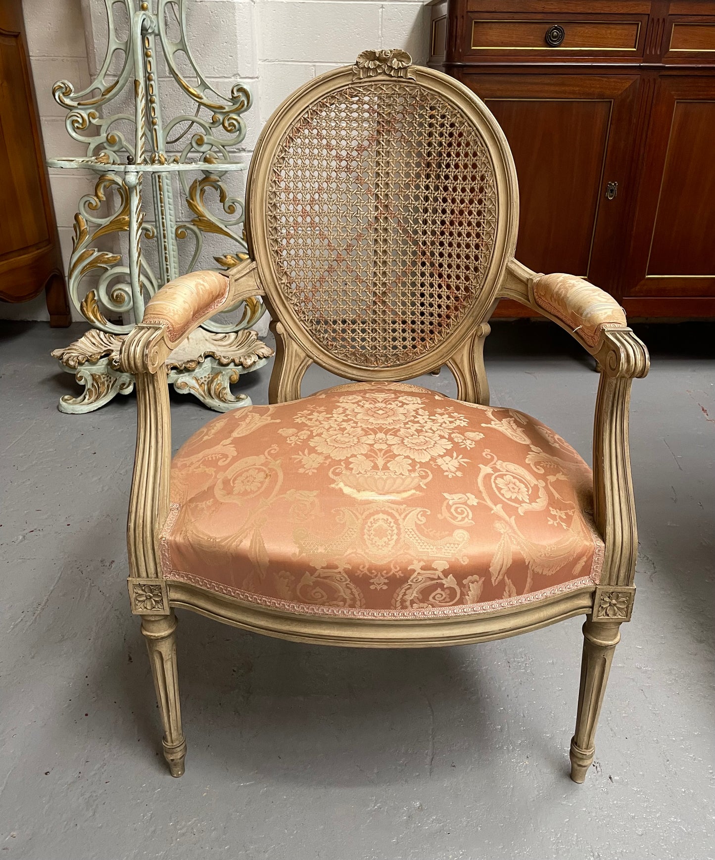 French Louis XV style cane back and upholstered seat fauteuil. With original paint and fabric is in original used condition with some stains and tears. Overall they are in good original used condition. Circa 1950's.