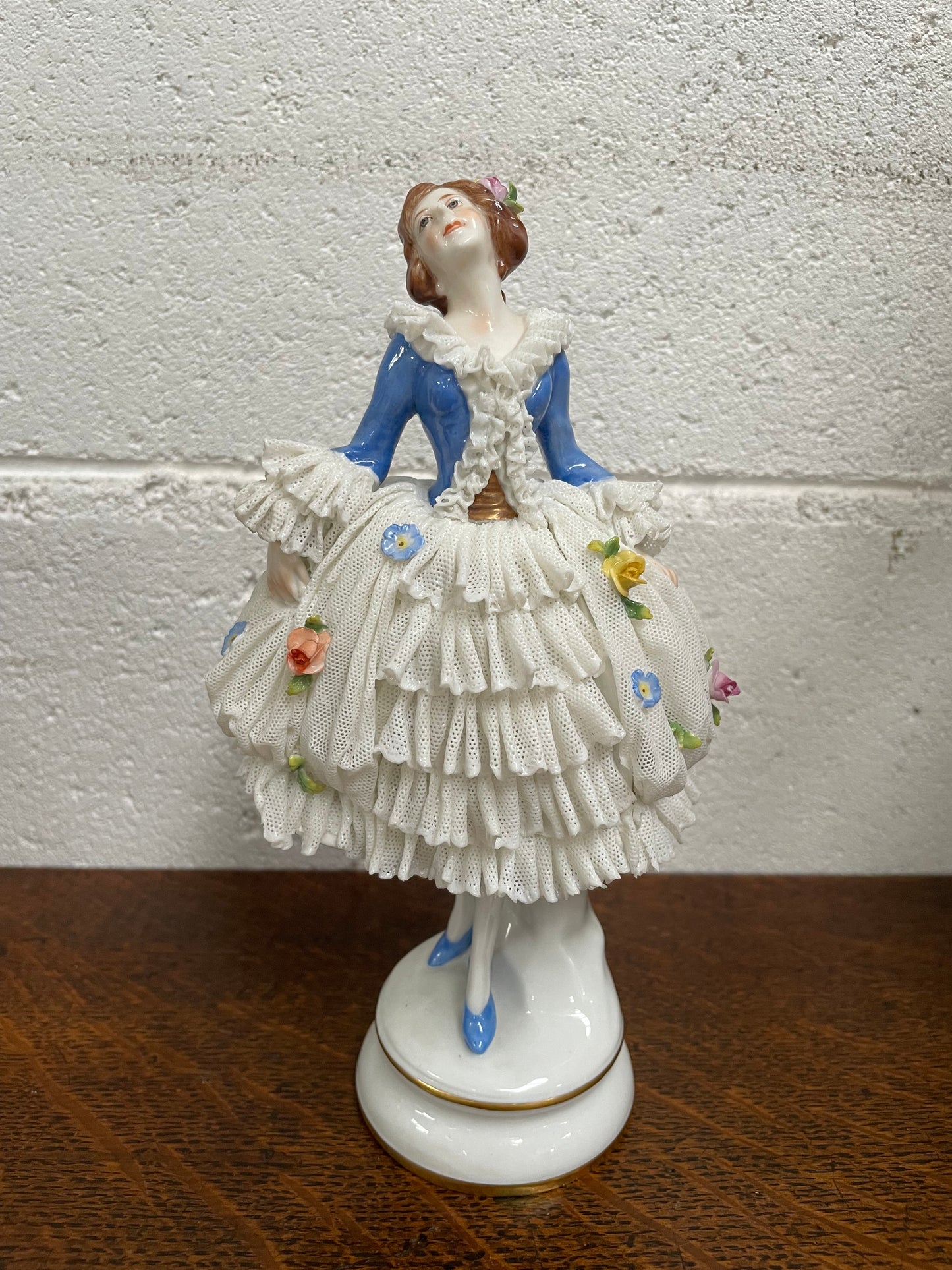 Dresden lace figurine stamped underneath and made in Germany. In good vintage condition with some slight damage to lace.