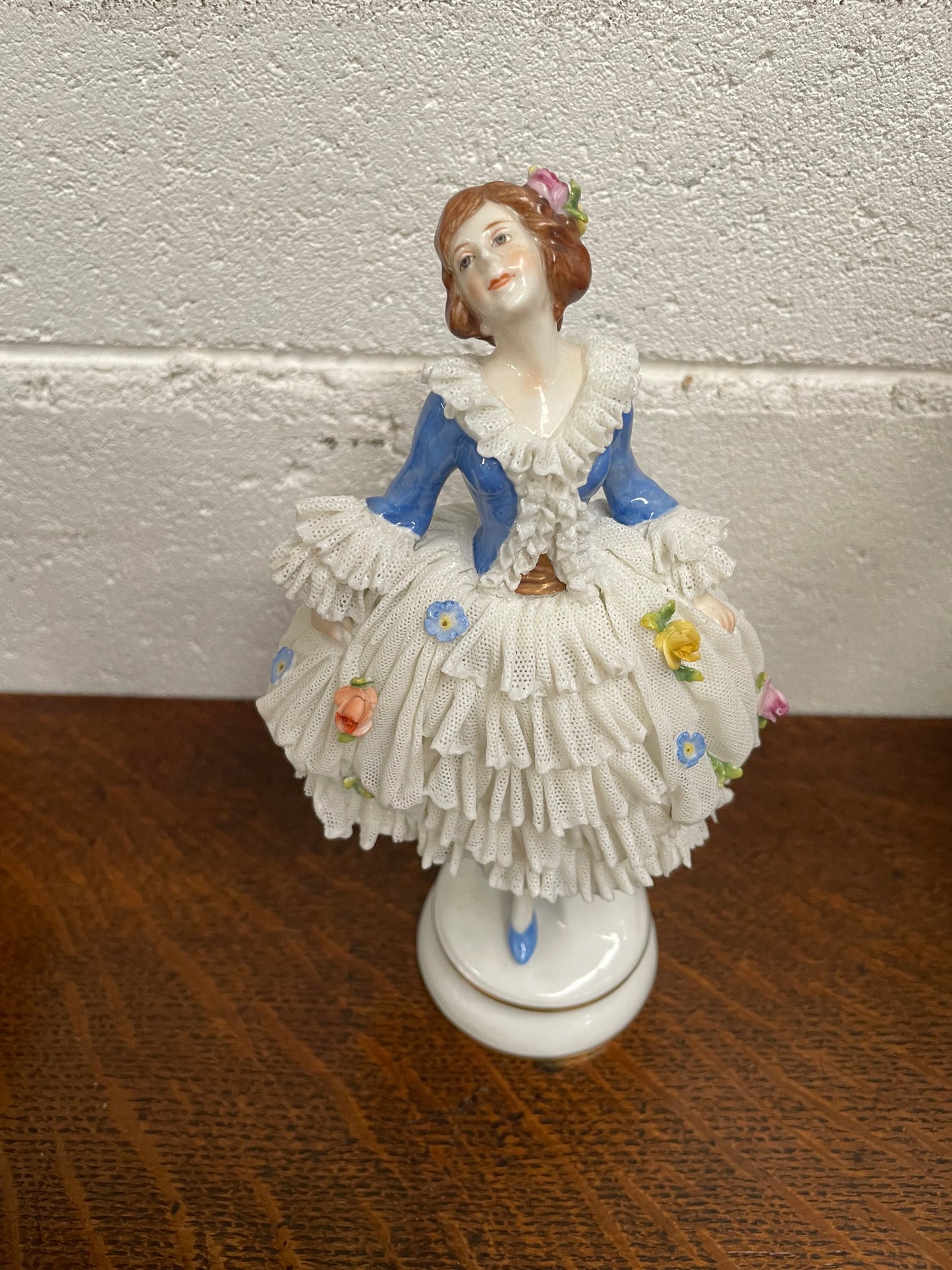 Dresden lace figurine stamped underneath and made in Germany. In good vintage condition with some slight damage to lace.