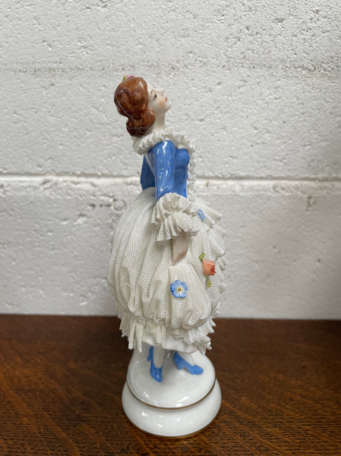 Dresden lace figurine stamped underneath and made in Germany. In good vintage condition with some slight damage to lace.