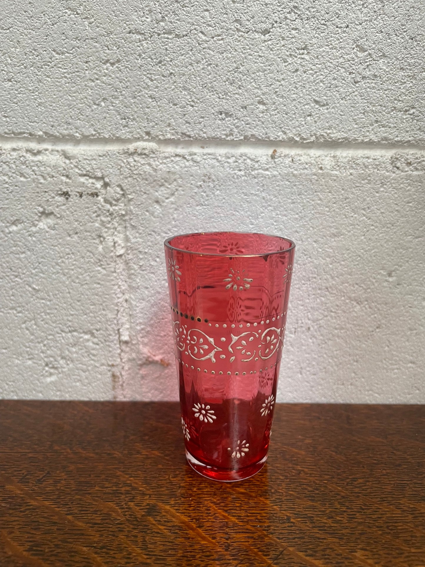Antique Ruby glass cup with beautiful enameling decoration. Sourced locally and in good original condition. Please view photos as they help form part of the description and condition. 