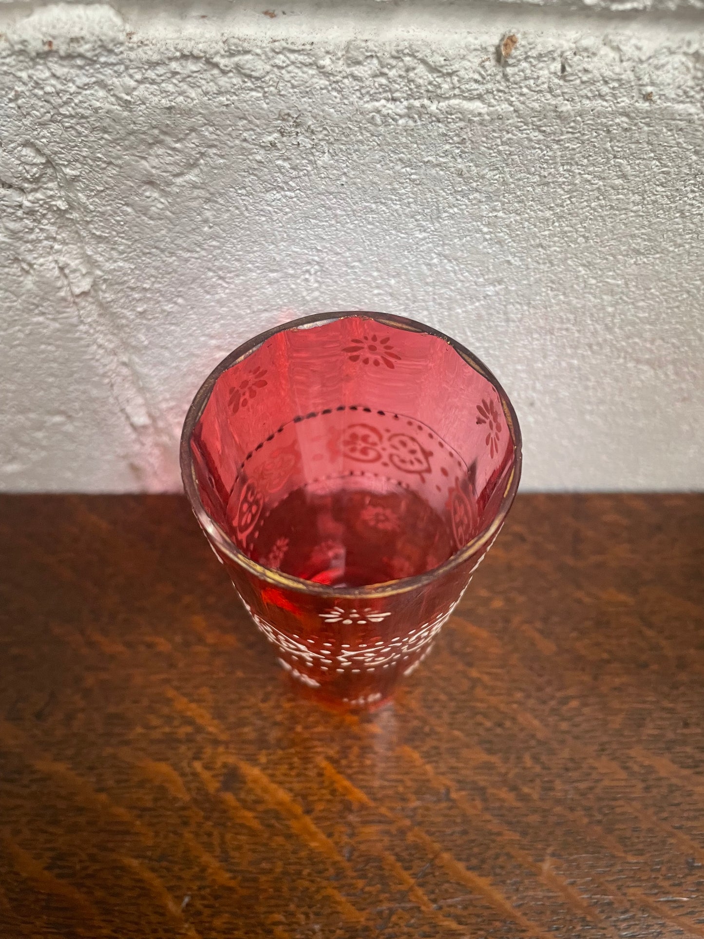 Antique Ruby glass cup with beautiful enameling decoration. Sourced locally and in good original condition. Please view photos as they help form part of the description and condition.