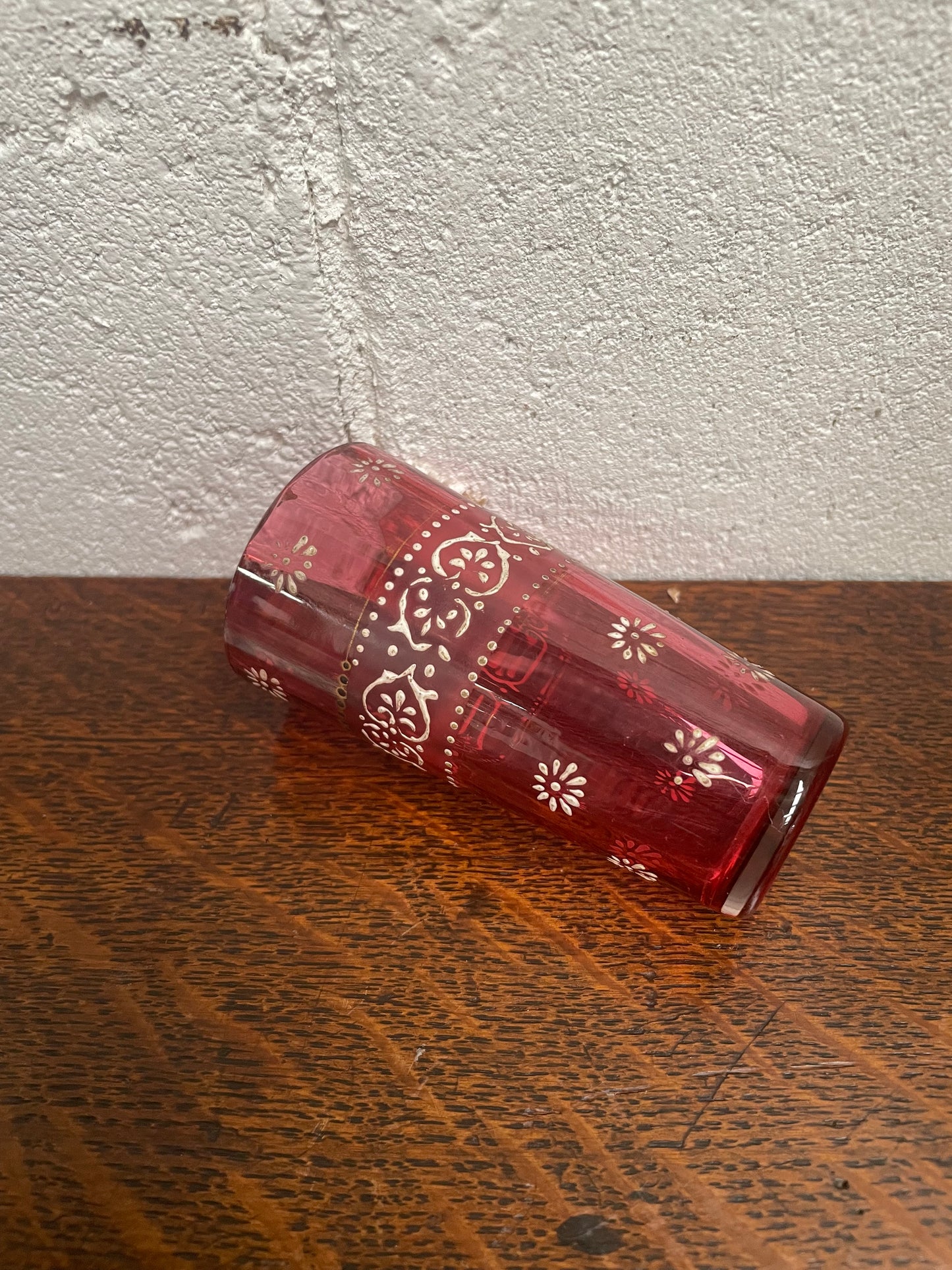 Antique Ruby glass cup with beautiful enameling decoration. Sourced locally and in good original condition. Please view photos as they help form part of the description and condition.