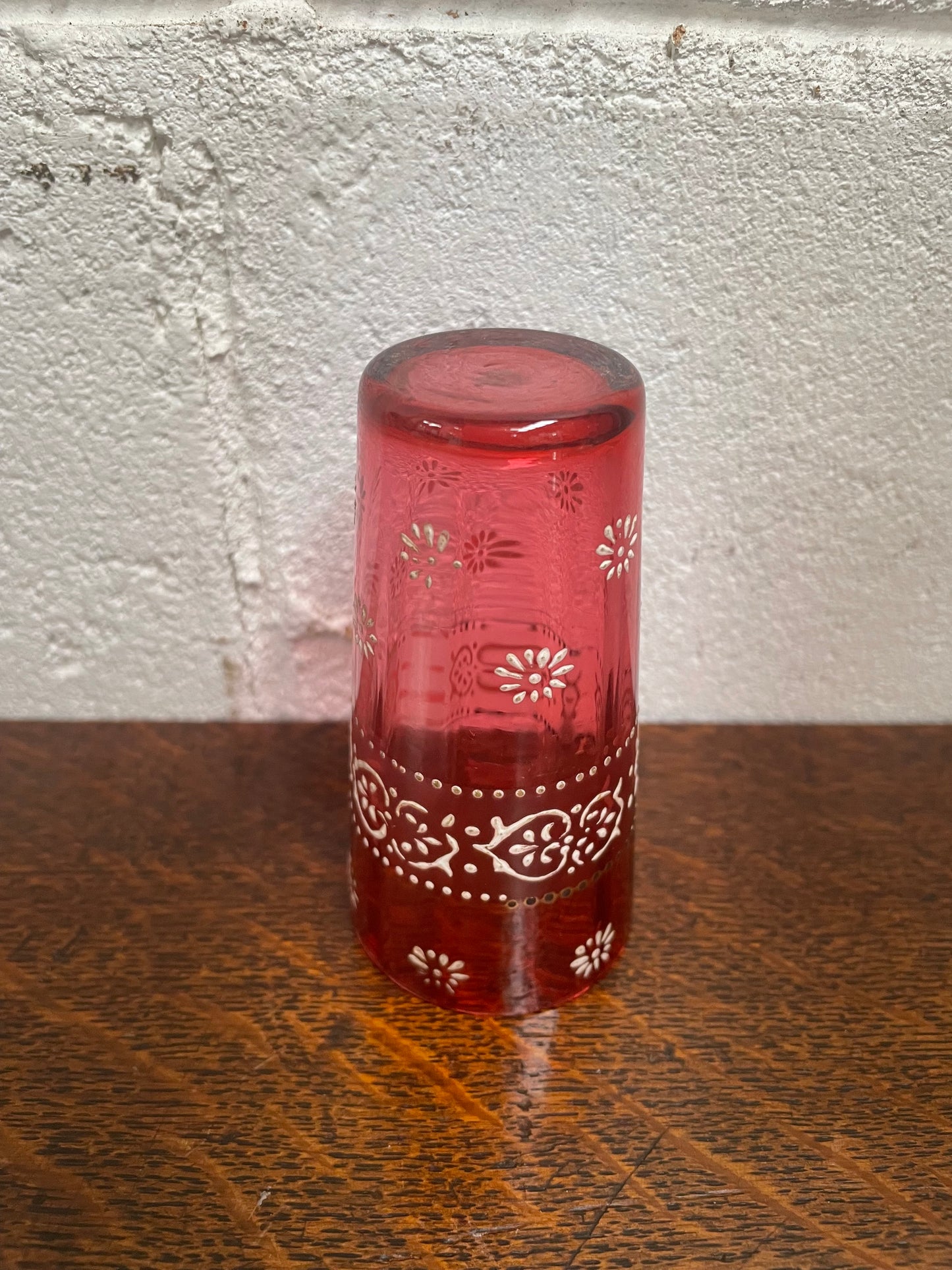 Antique Ruby glass cup with beautiful enameling decoration. Sourced locally and in good original condition. Please view photos as they help form part of the description and condition.