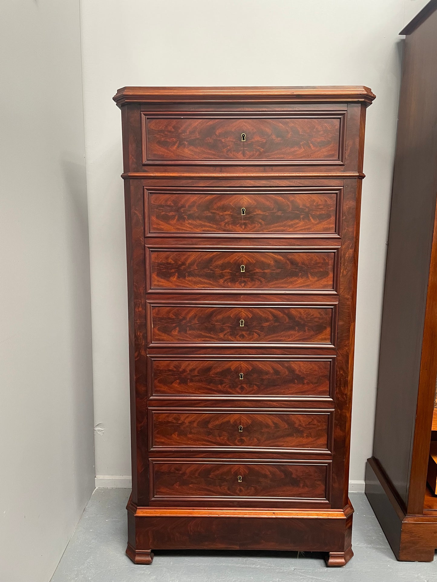 Early 19th Century Louis Phillipe style flame mahogany secretaire drawers. Presents as a seven drawer chest however three drawers are a drop down panel to a beautifully fitted secretaire/desk area. Sourced directly from France and in good original condition especially for its age.