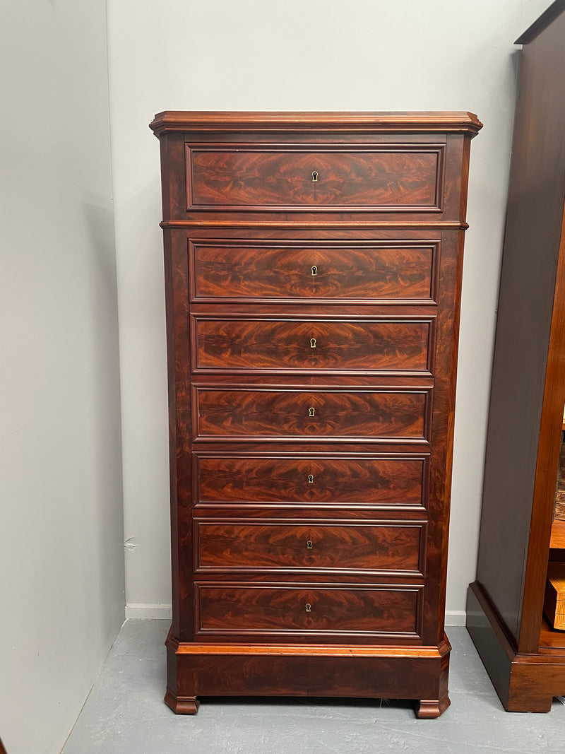 Early 19th Century Louis Phillipe style flame mahogany secretaire drawers. Presents as a seven drawer chest however three drawers are a drop down panel to a beautifully fitted secretaire/desk area. Sourced directly from France and in good original condition especially for its age.