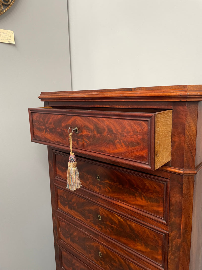 Early 19th Century Louis Phillipe style flame mahogany secretaire drawers. Presents as a seven drawer chest however three drawers are a drop down panel to a beautifully fitted secretaire/desk area. Sourced directly from France and in good original condition especially for its age.