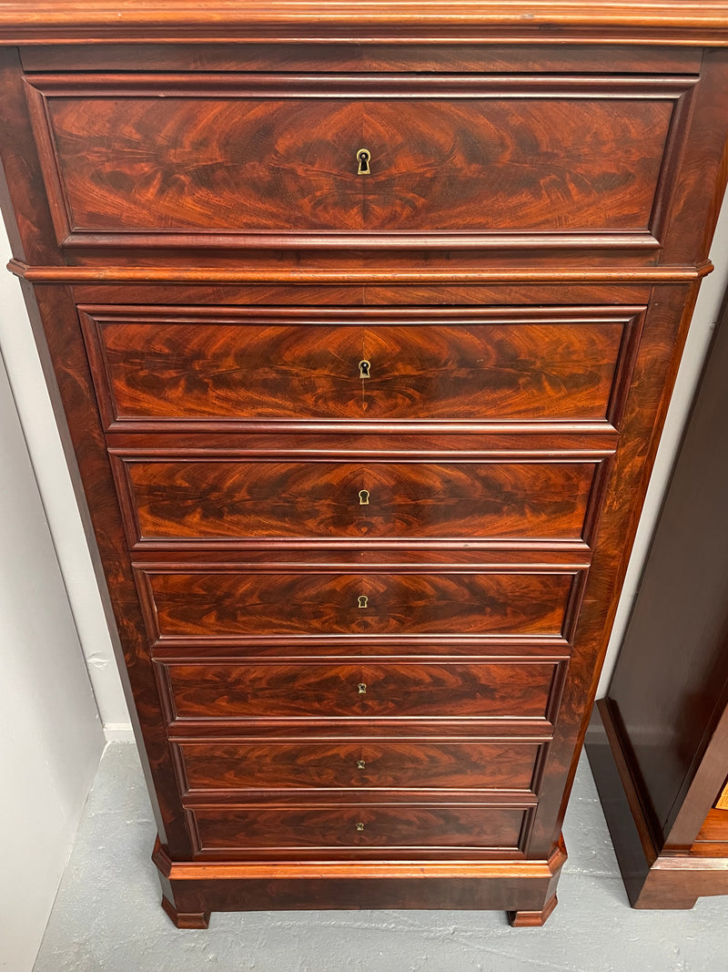 Early 19th Century Louis Phillipe style flame mahogany secretaire drawers. Presents as a seven drawer chest however three drawers are a drop down panel to a beautifully fitted secretaire/desk area. Sourced directly from France and in good original condition especially for its age.