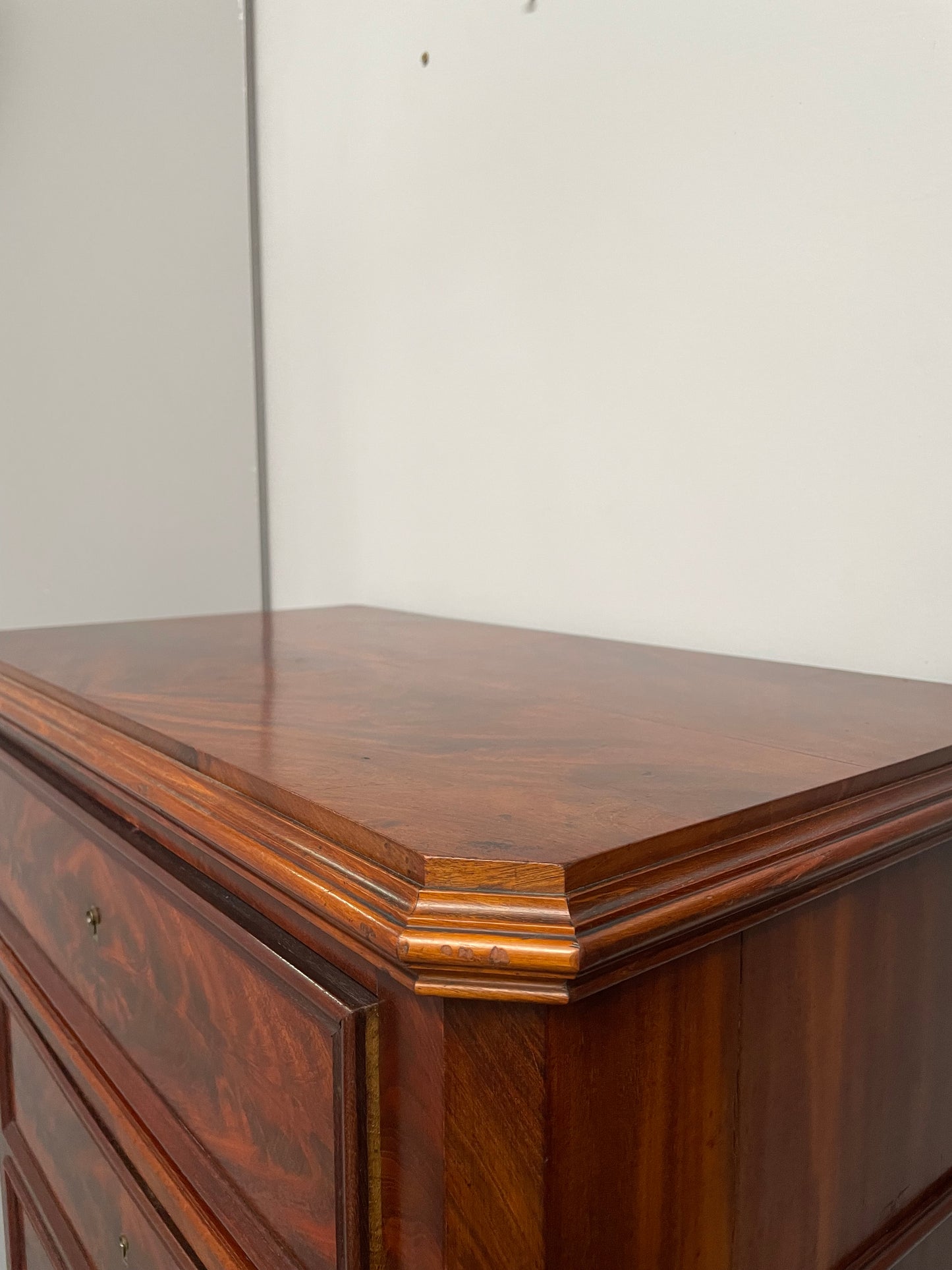 Early 19th Century Louis Phillipe style flame mahogany secretaire drawers. Presents as a seven drawer chest however three drawers are a drop down panel to a beautifully fitted secretaire/desk area. Sourced directly from France and in good original condition especially for its age.