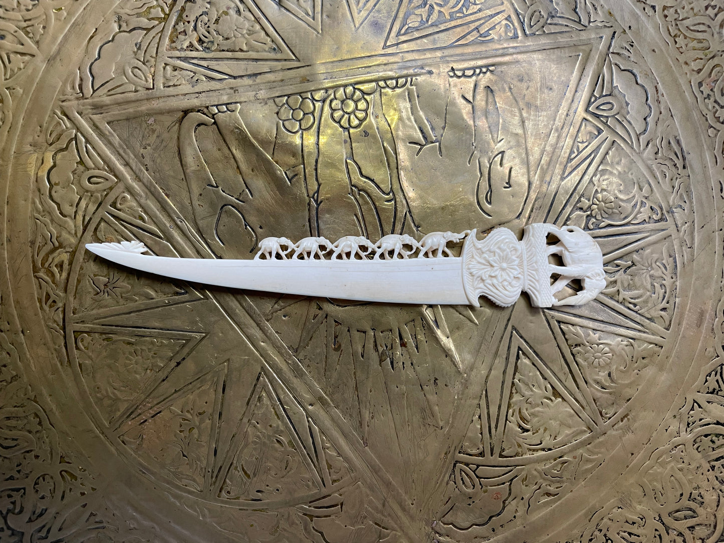 Interesting hand carved bond letter opener featuring herd of elephants. In good original condition.