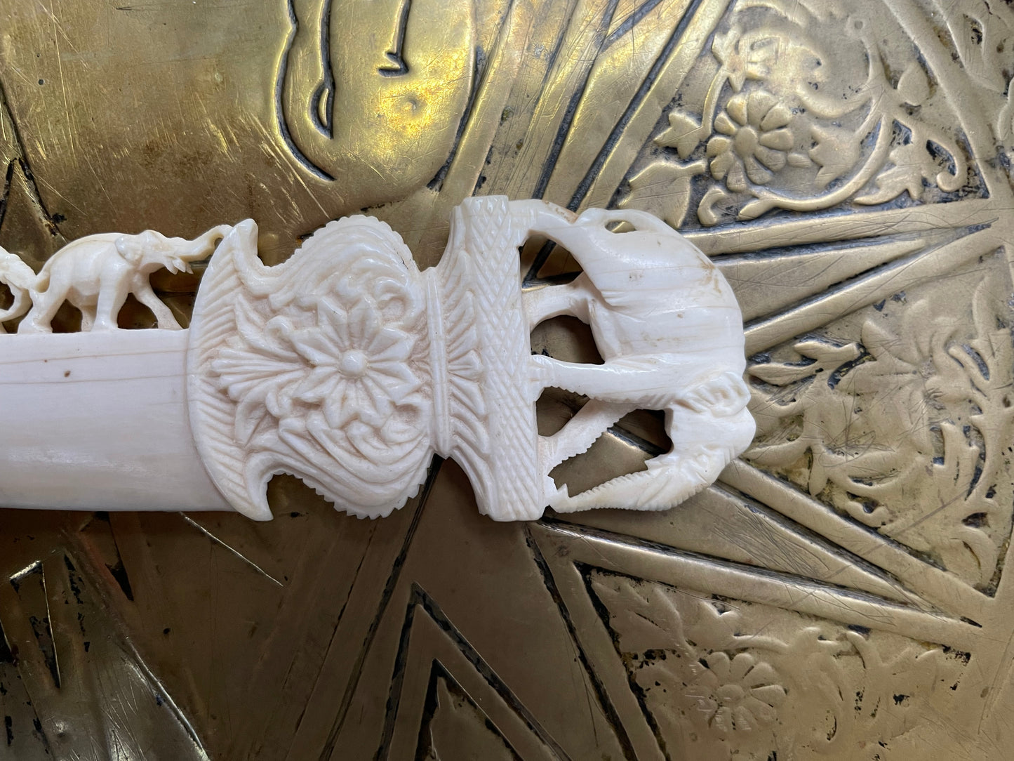 Interesting hand carved bond letter opener featuring herd of elephants. In good original condition.