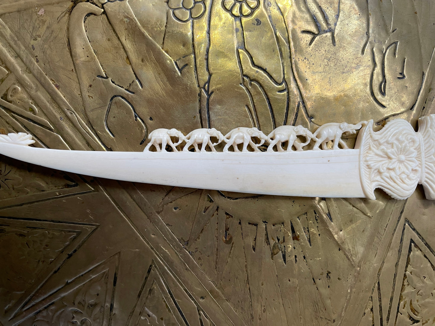 Interesting hand carved bond letter opener featuring herd of elephants. In good original condition.