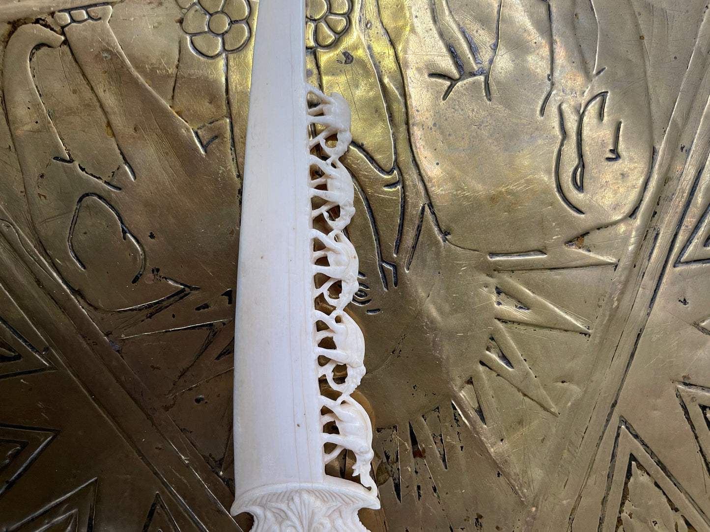 Interesting hand carved bond letter opener featuring herd of elephants. In good original condition.