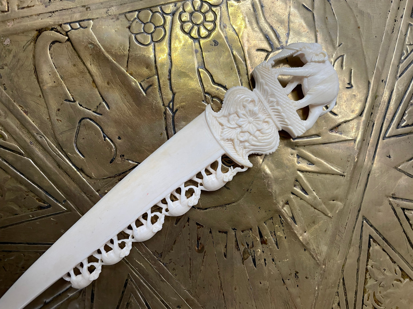 Interesting hand carved bond letter opener featuring herd of elephants. In good original condition.