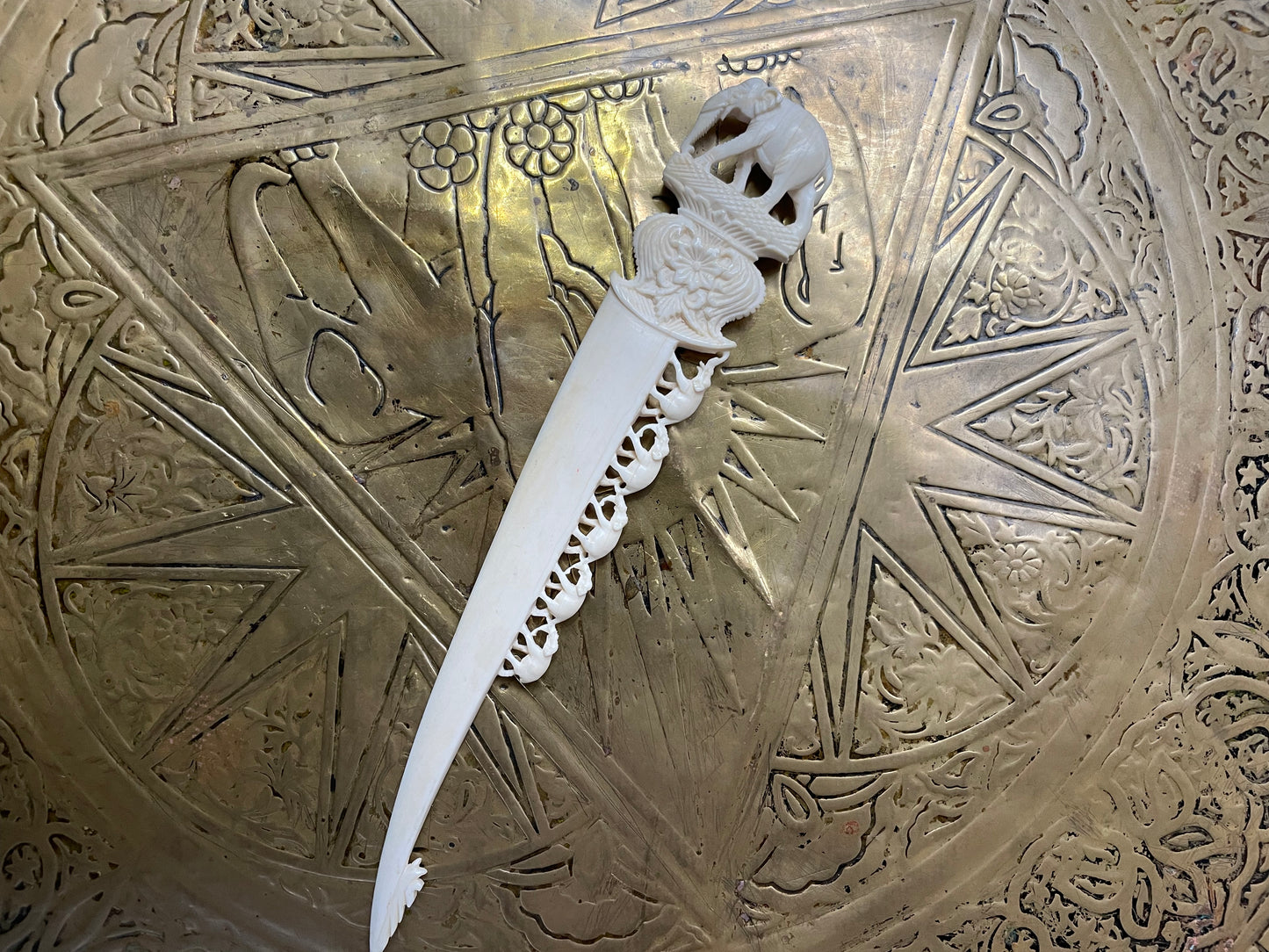 Interesting hand carved bond letter opener featuring herd of elephants. In good original condition.