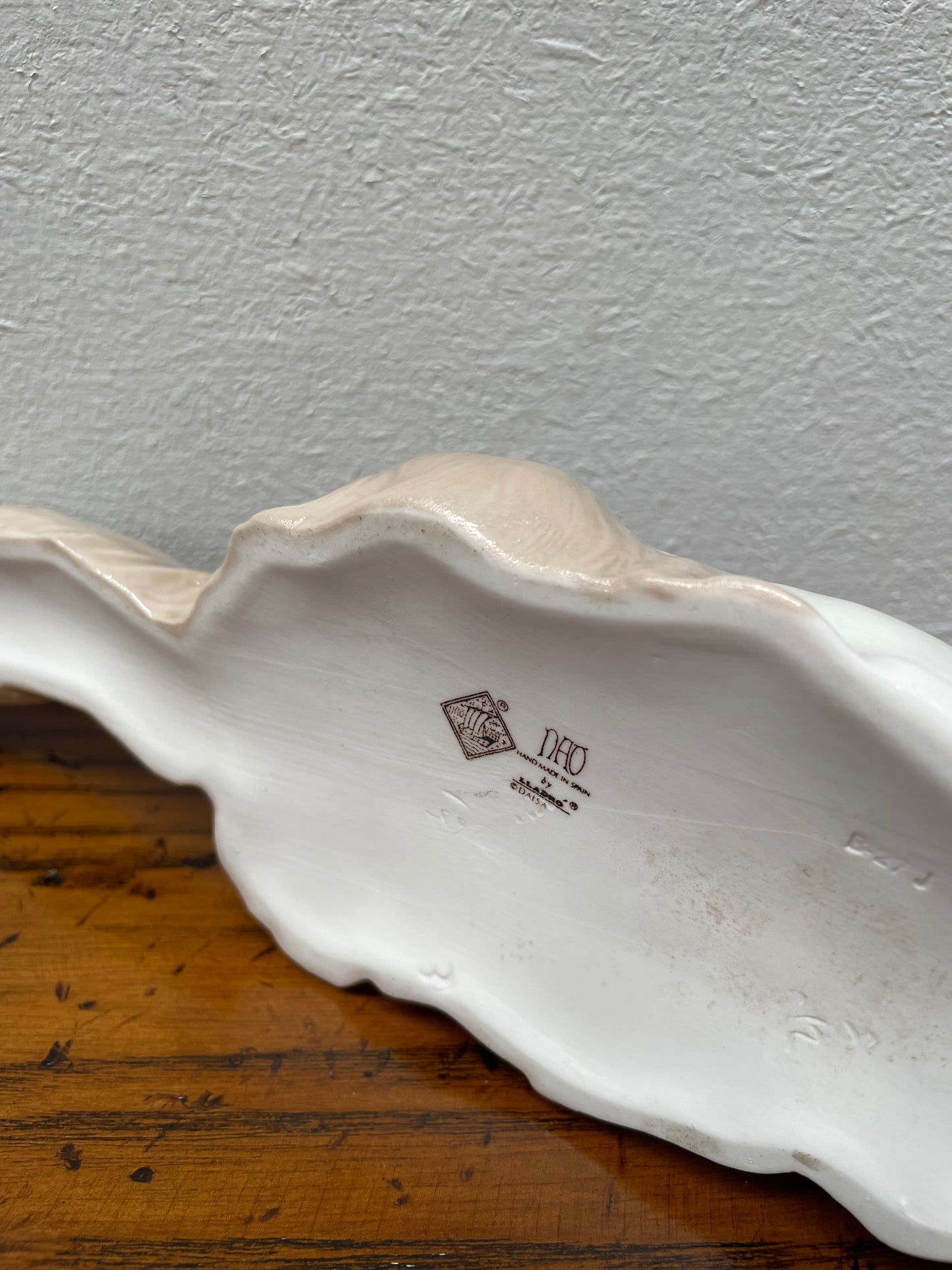 This is a beautiful NAO by Lladro porcelain figurine of reclining Angora Persian cat made by sculptor Fulgencio Garcia in 1992. It has a glossy finish. It is marked NAO hand made in Spain by Lladro on the underside. In very good condition.