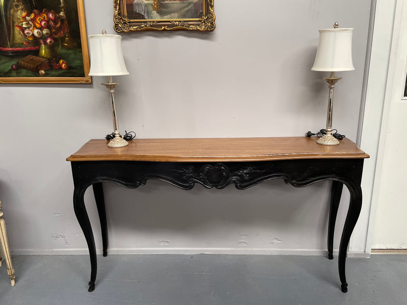 Louis XV style long console table with an ebonized black base and timber top. It is in good original detailed condition and has been sourced directly from France.