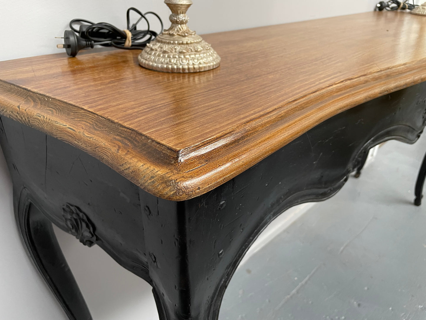 Louis XV style long console table with an ebonized black base and timber top. It is in good original detailed condition and has been sourced directly from France.