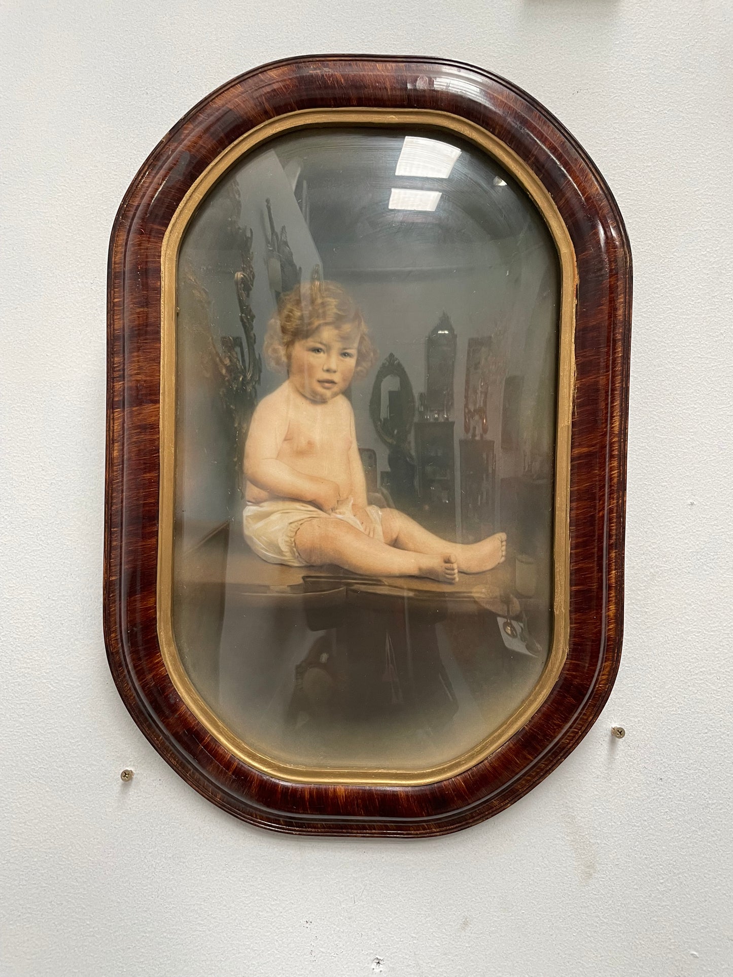 Lovely Art Deco photo frame with concave glass and a beautiful photo of a young child . Ready to hang. Sourced locally and in good original condition.