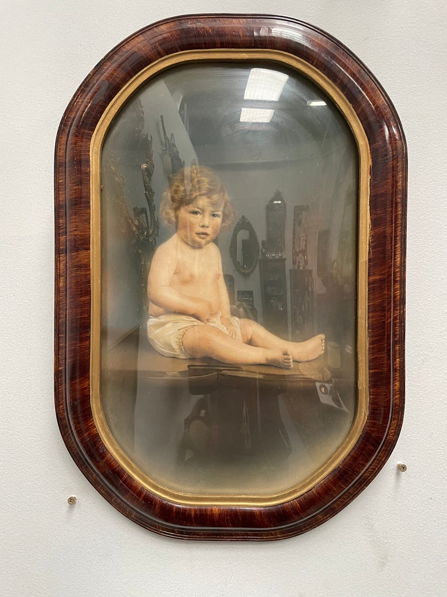 Lovely Art Deco photo frame with concave glass and a beautiful photo of a young child . Ready to hang. Sourced locally and in good original condition.