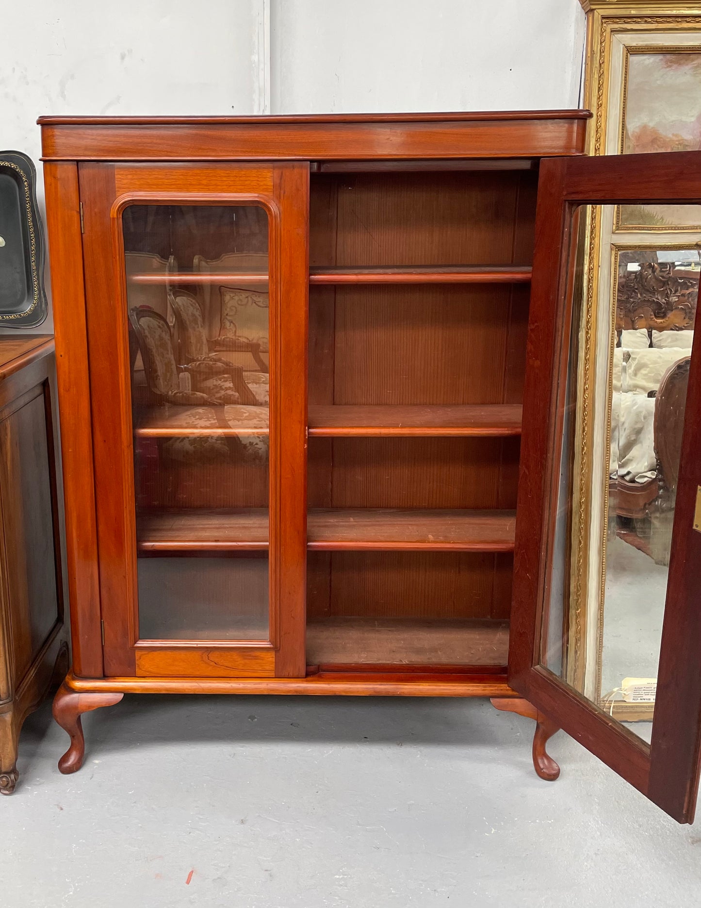 Practical late Victorian Cedar two door bookcase on cabriole feet and adjustable shelves. In good condition. Please see photos as they form part of the description. Circa: 1890's