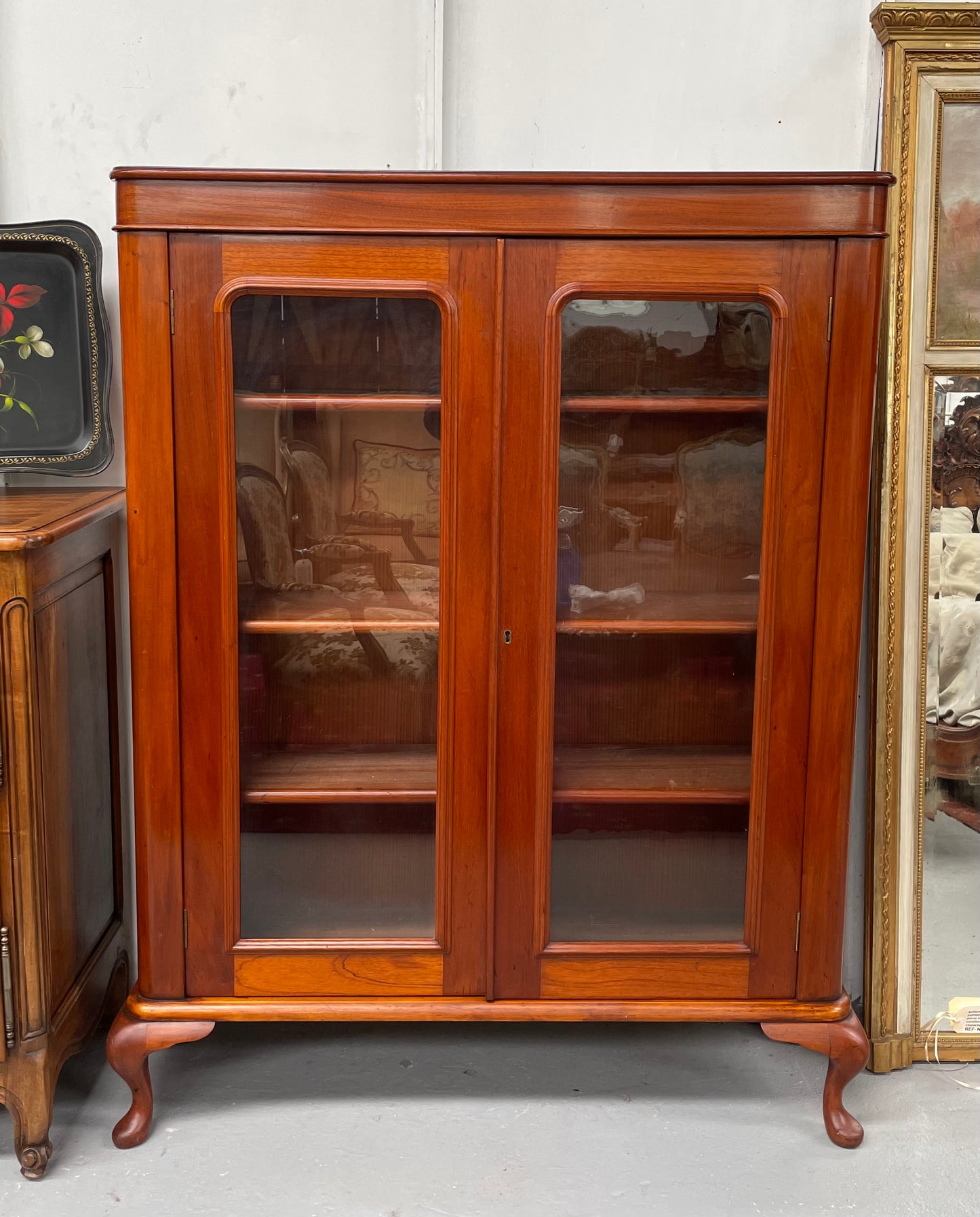 Practical late Victorian Cedar two door bookcase on cabriole feet and adjustable shelves. In good condition. Please see photos as they form part of the description. Circa: 1890's