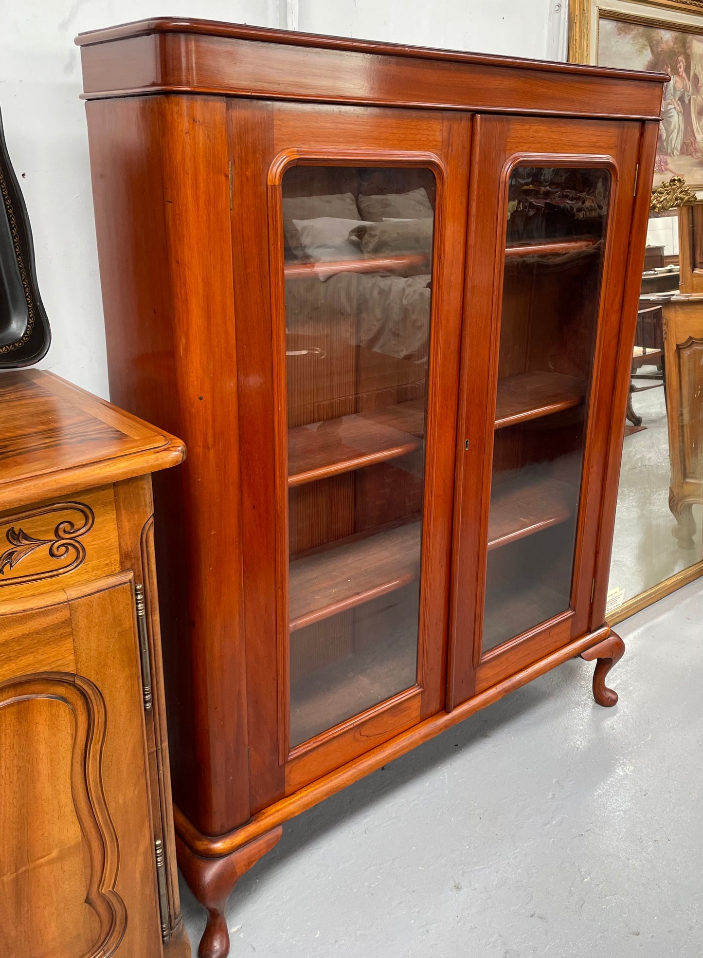 Practical late Victorian Cedar two door bookcase on cabriole feet and adjustable shelves. In good condition. Please see photos as they form part of the description. Circa: 1890's