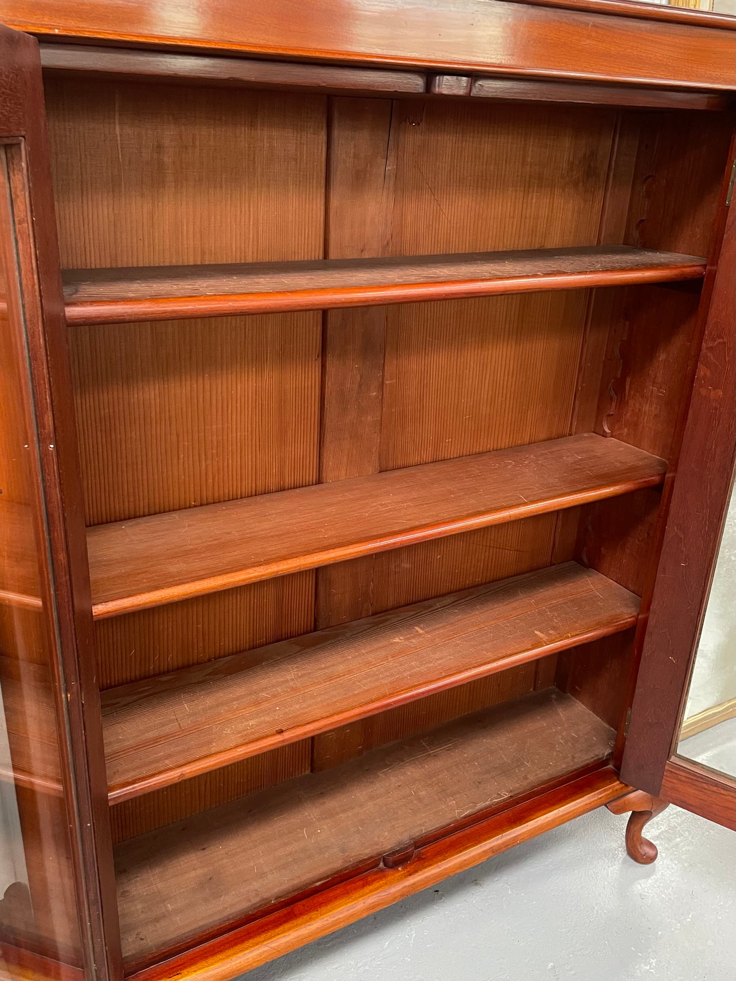 Practical late Victorian Cedar two door bookcase on cabriole feet and adjustable shelves. In good condition. Please see photos as they form part of the description. Circa: 1890's
