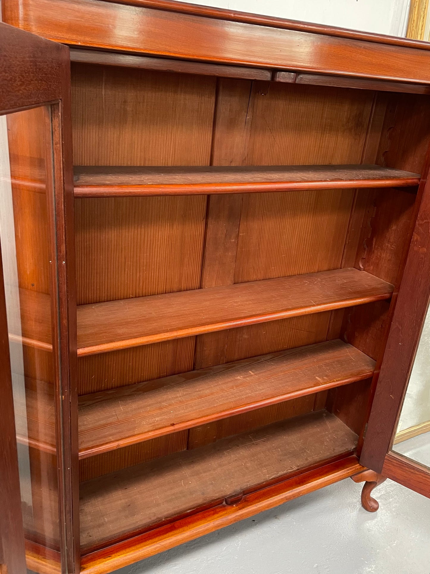 Practical late Victorian Cedar two door bookcase on cabriole feet and adjustable shelves. In good condition. Please see photos as they form part of the description. Circa: 1890's