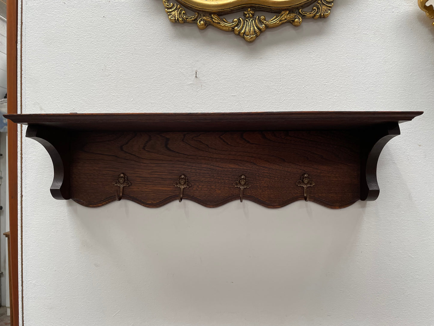 Charming French oak four Cherub shaped hook coat rack with shelf. Sourced from France and is in good original condition.