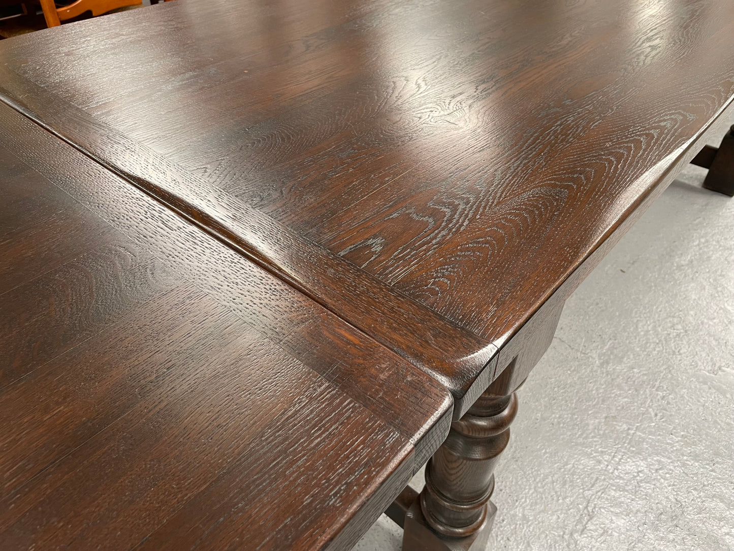 Stunning stretcher base antique oak farmhouse dining table with two extension leaves that can be added to either side. Stretcher base and turned legs. Sourced directly from France and in good original detailed condition.