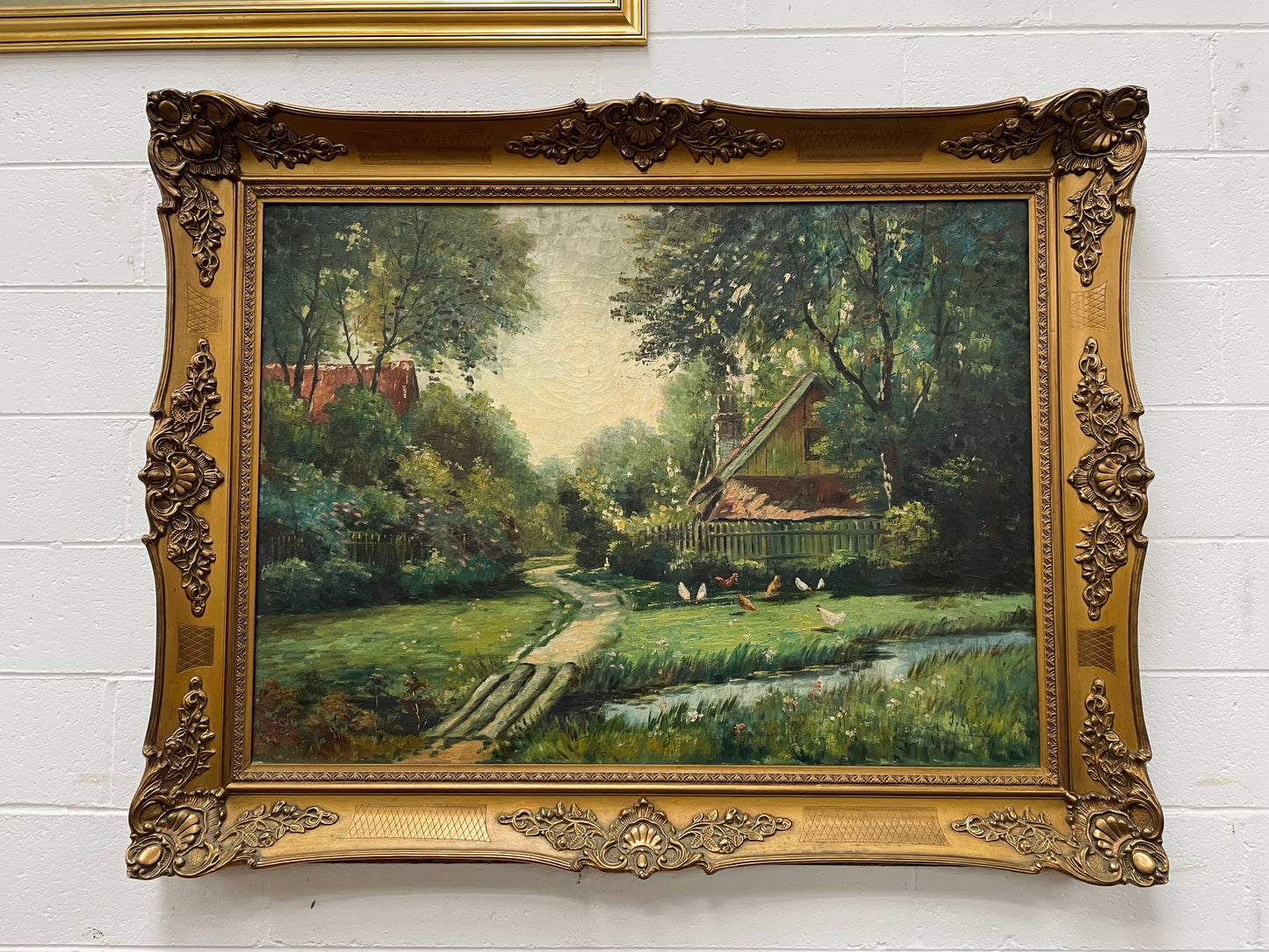Fabulous large French oil on canvas depicting a country house with chickens around the garden. It is framed in a lovely ornate gold frame and in good original condition.