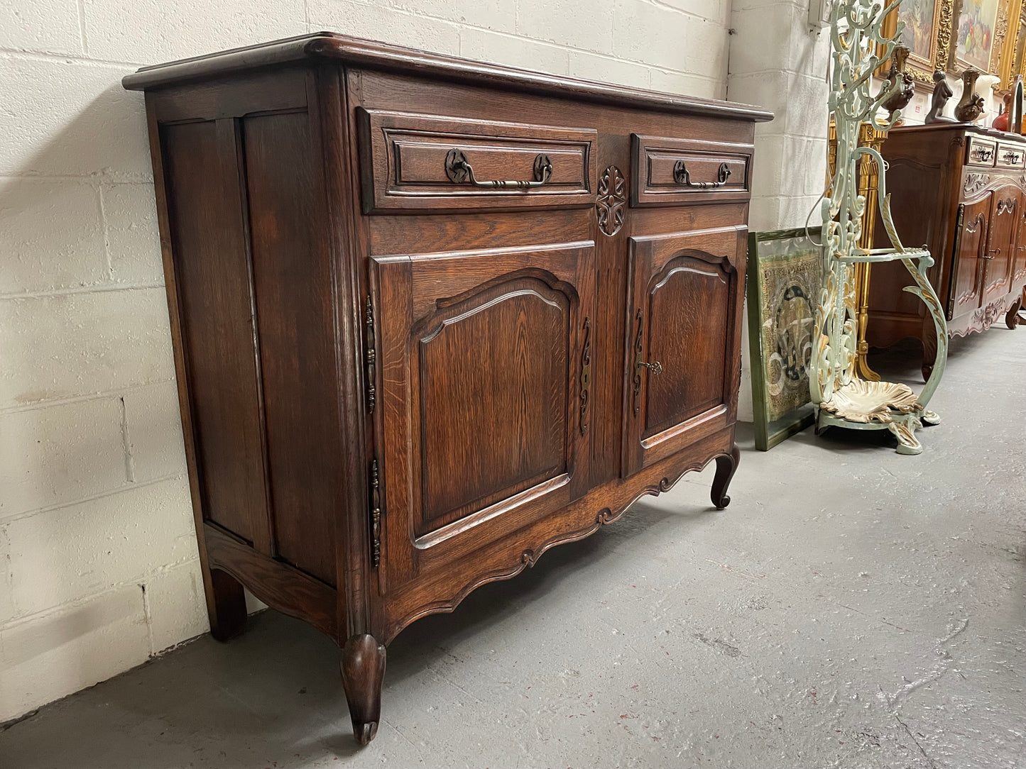 Charming French Oak provincial two door buffet. It has two drawers and a cupboard with two doors and one shelf. It is in good original condition and has been sourced directly from France.