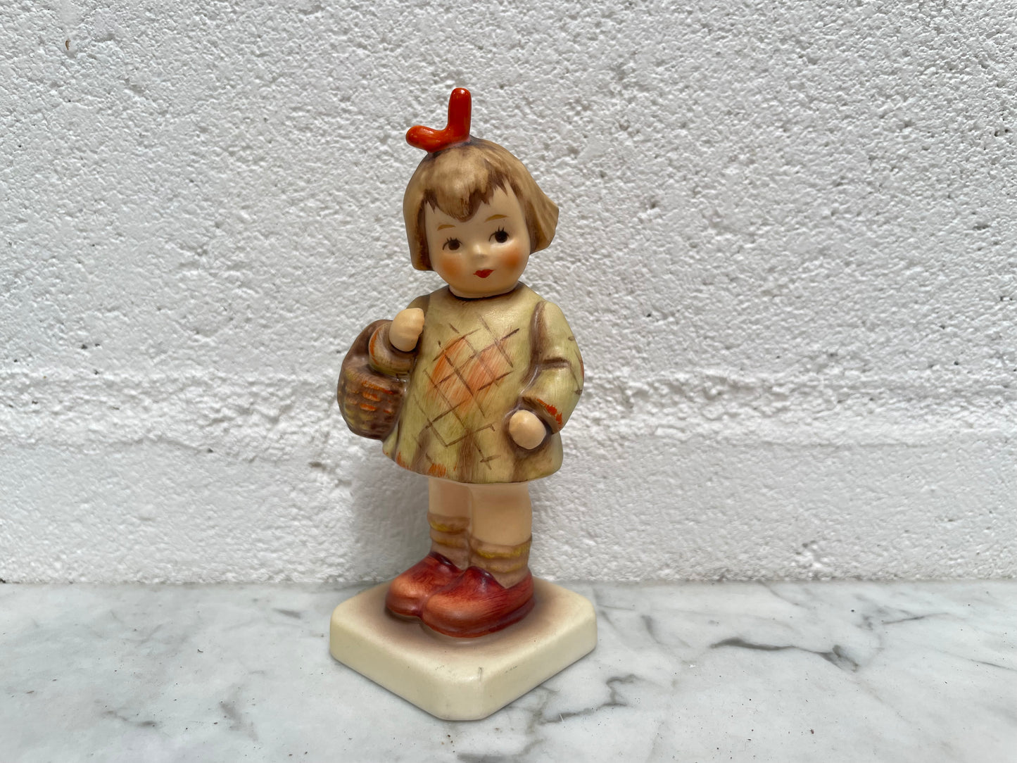 Beautiful Hummel Figurine "I Bought You a Gift", of a girl with her basket. In good original condition. Please see photos as they form part of the description.