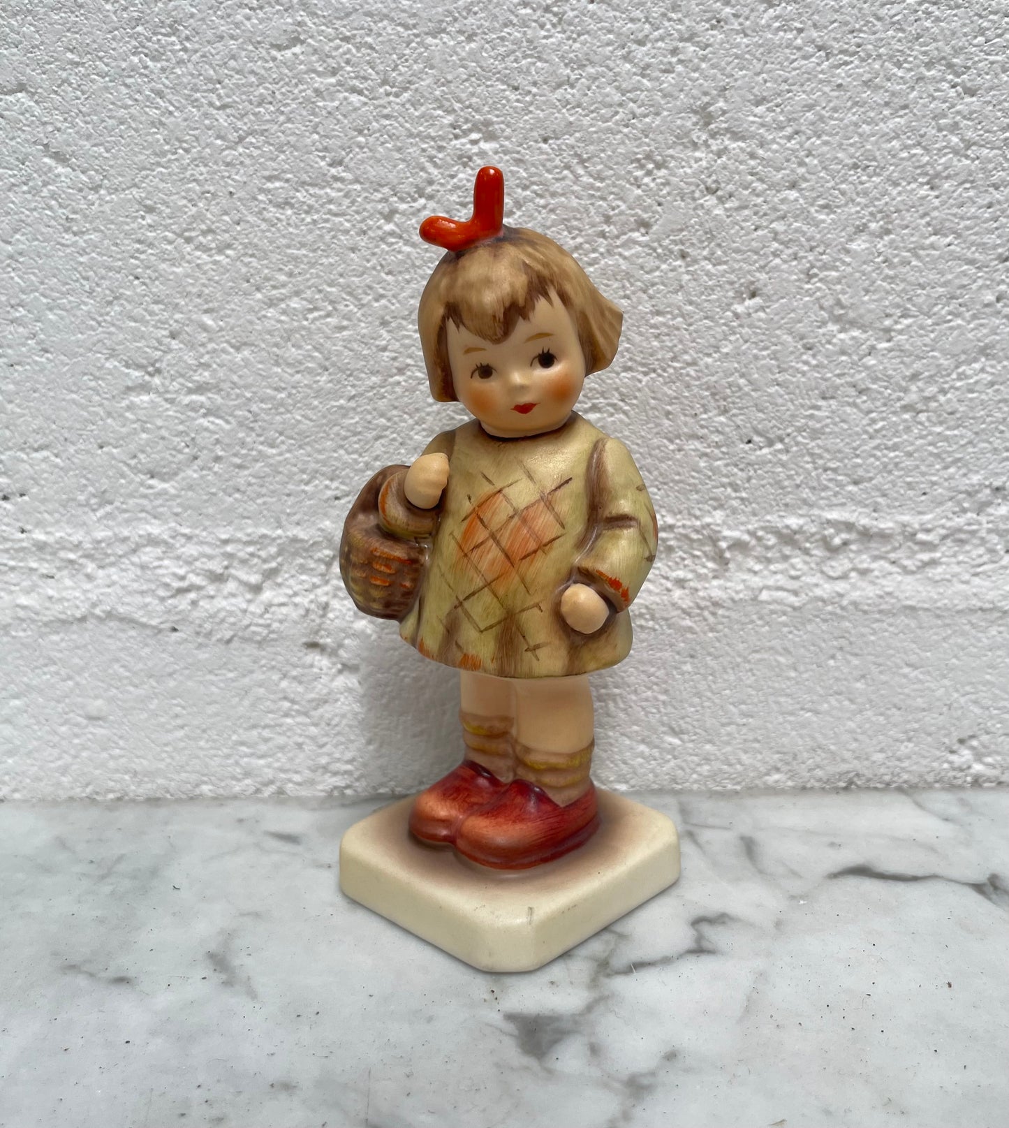 Beautiful Hummel Figurine "I Bought You a Gift", of a girl with her basket. In good original condition. Please see photos as they form part of the description.