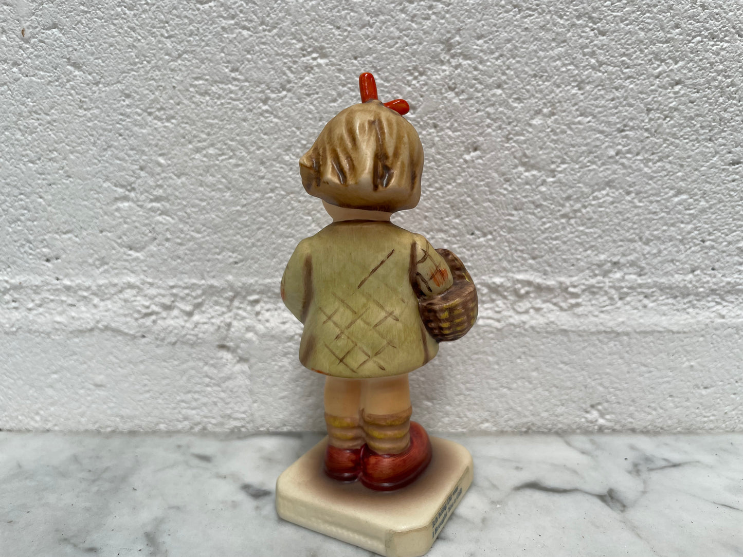 Beautiful Hummel Figurine "I Bought You a Gift", of a girl with her basket. In good original condition. Please see photos as they form part of the description.