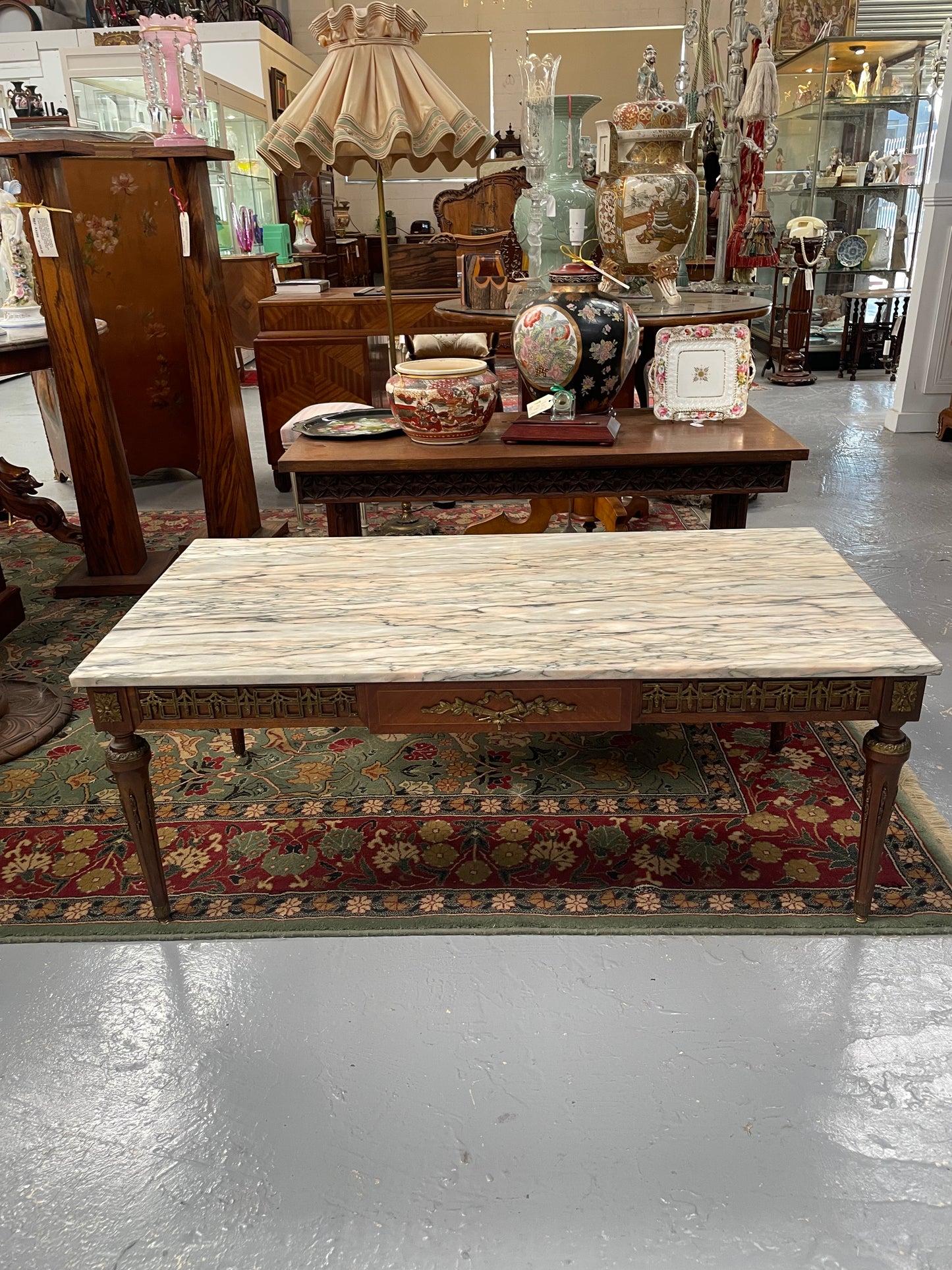 Impressive Louis XVI style walnut coffee table. Stunning marble top, gilt mounts and fluted legs. Circa: 1950's. In good original condition.