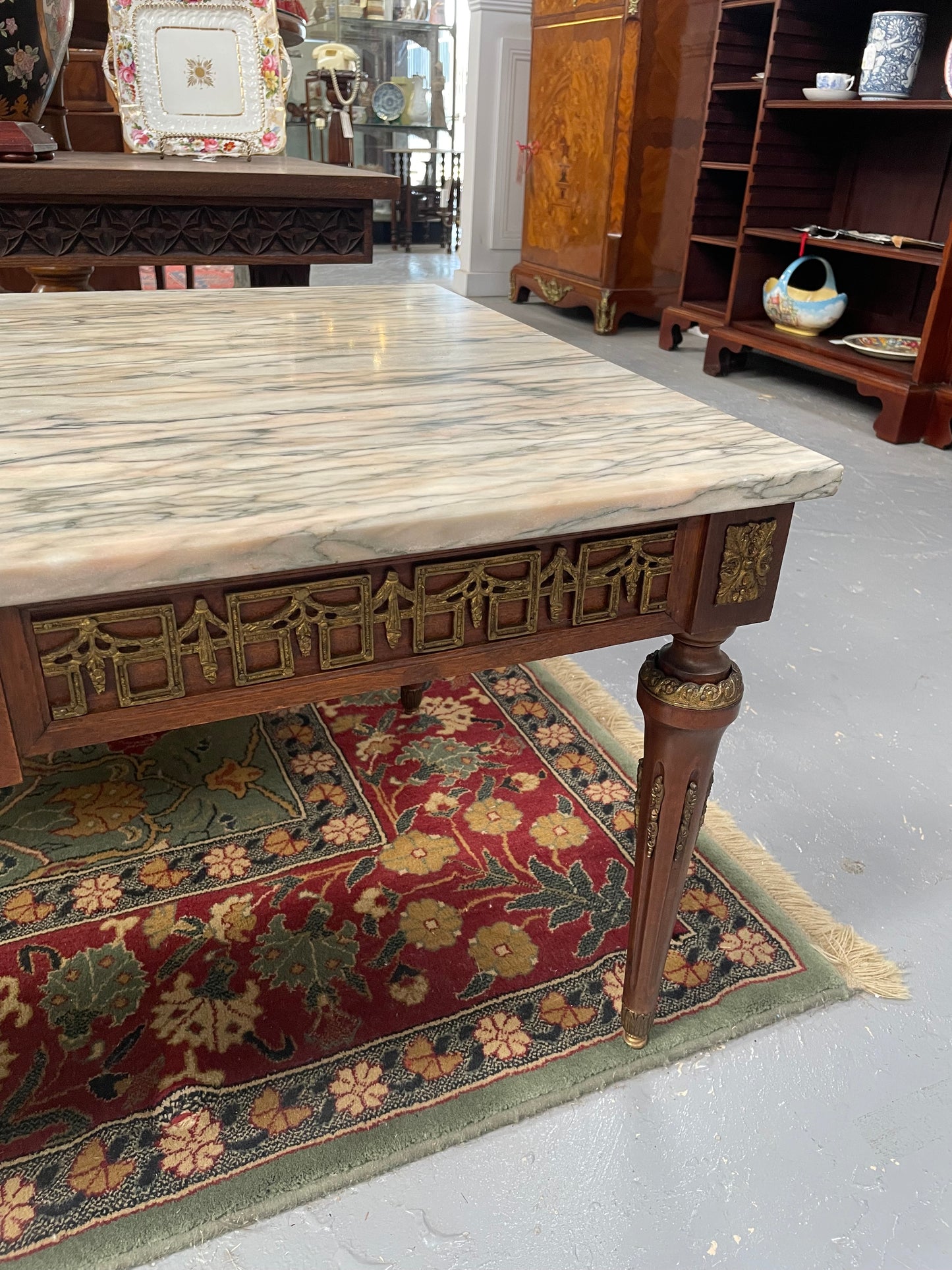 Impressive Louis XVI style walnut coffee table. Stunning marble top, gilt mounts and fluted legs. Circa: 1950's. In good original condition.