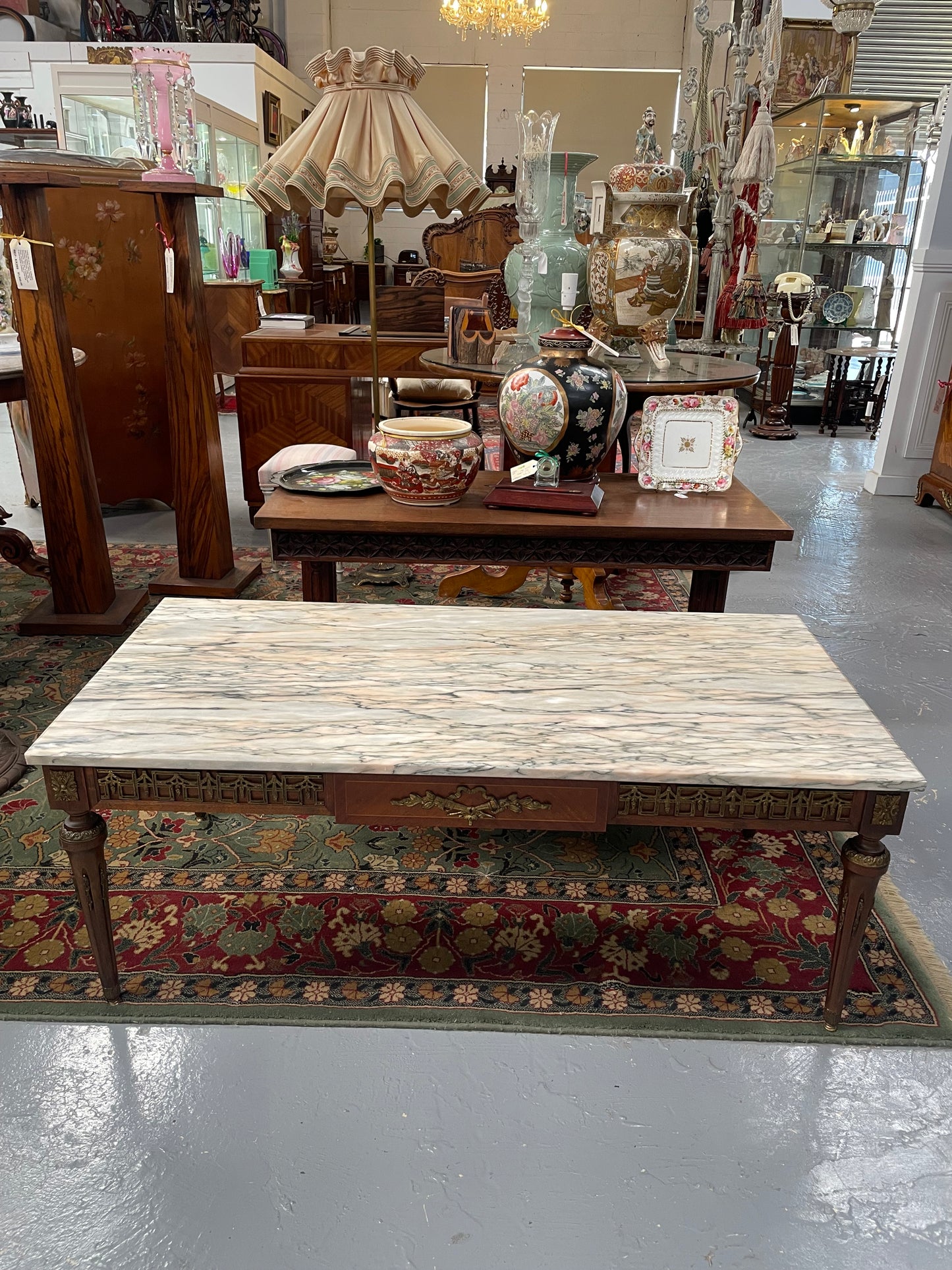 Impressive Louis XVI style walnut coffee table. Stunning marble top, gilt mounts and fluted legs. Circa: 1950's. In good original condition.