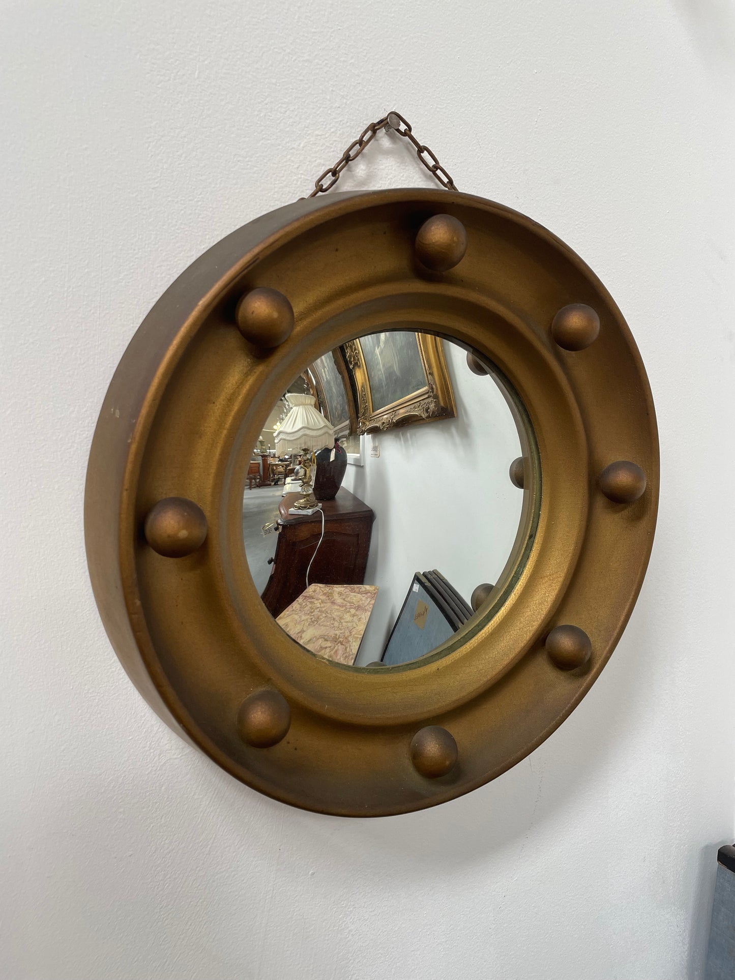 An elegant compact round convex wall mirror with lovely details that has been sourced directly from France. It is in good original condition. Please see photos as they form part of the description and condition.