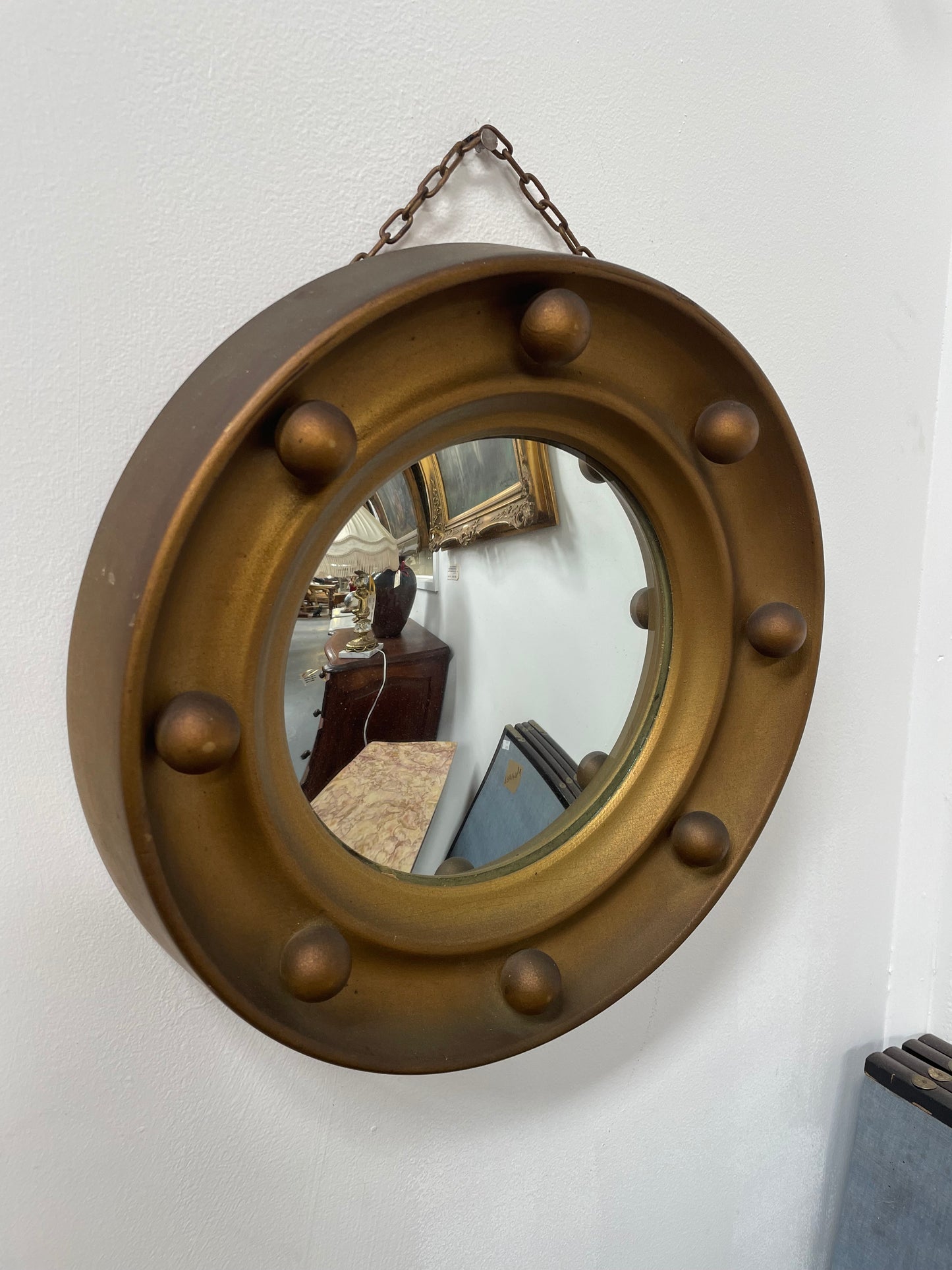 An elegant compact round convex wall mirror with lovely details that has been sourced directly from France. It is in good original condition. Please see photos as they form part of the description and condition.