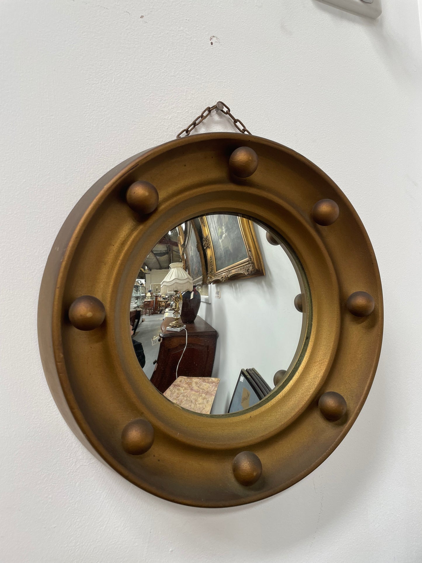 An elegant compact round convex wall mirror with lovely details that has been sourced directly from France. It is in good original condition. Please see photos as they form part of the description and condition.