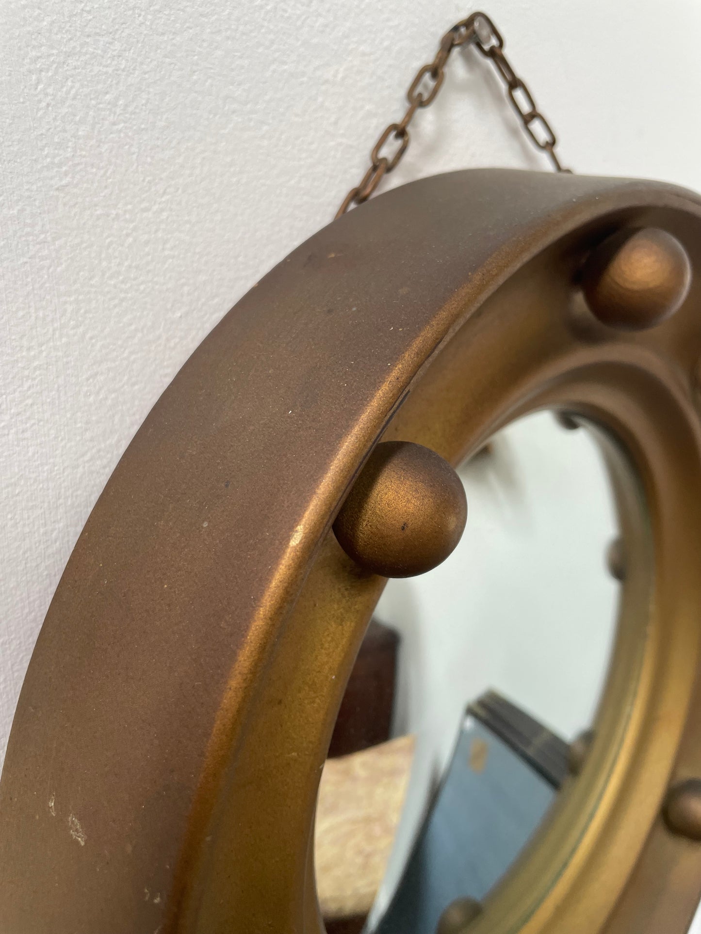 An elegant compact round convex wall mirror with lovely details that has been sourced directly from France. It is in good original condition. Please see photos as they form part of the description and condition.