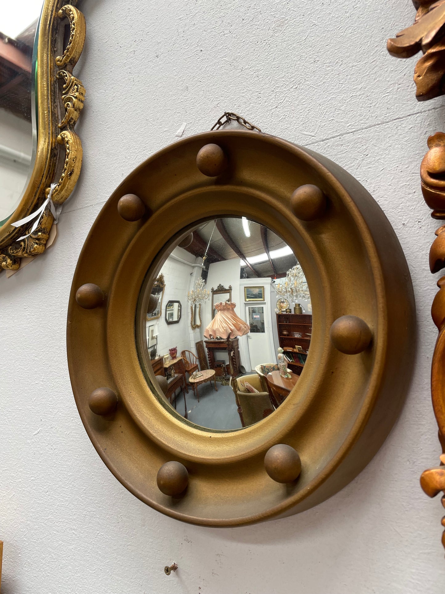 An elegant compact round convex wall mirror with lovely details that has been sourced directly from France. It is in good original condition. Please see photos as they form part of the description and condition.