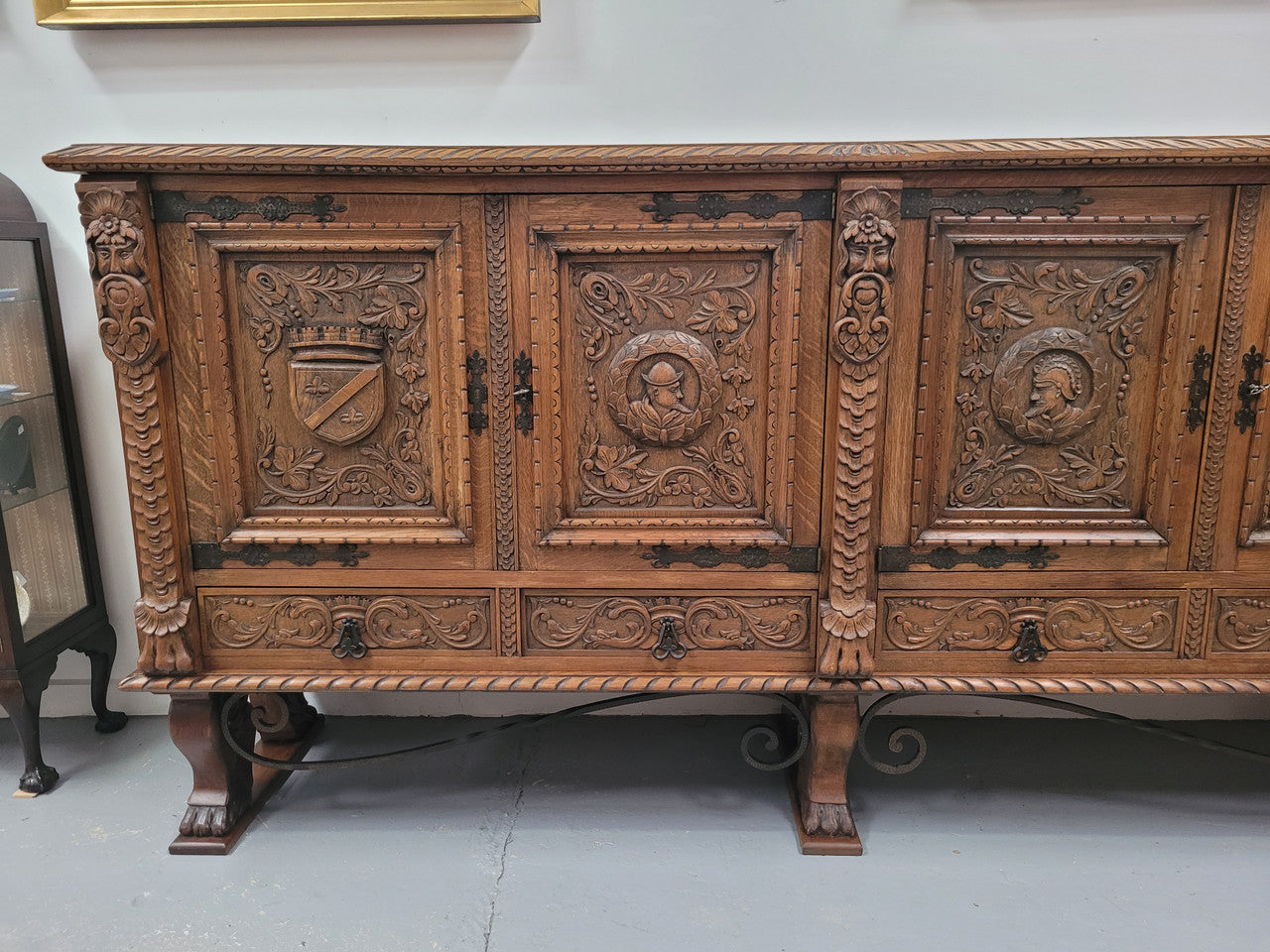 Large French Oak Renaissance style four door sideboard/buffet. Great decorative item with amazing carvings and stunning iron work on base. It is in good original detailed condition. Can pull apart completely making it easier to move.