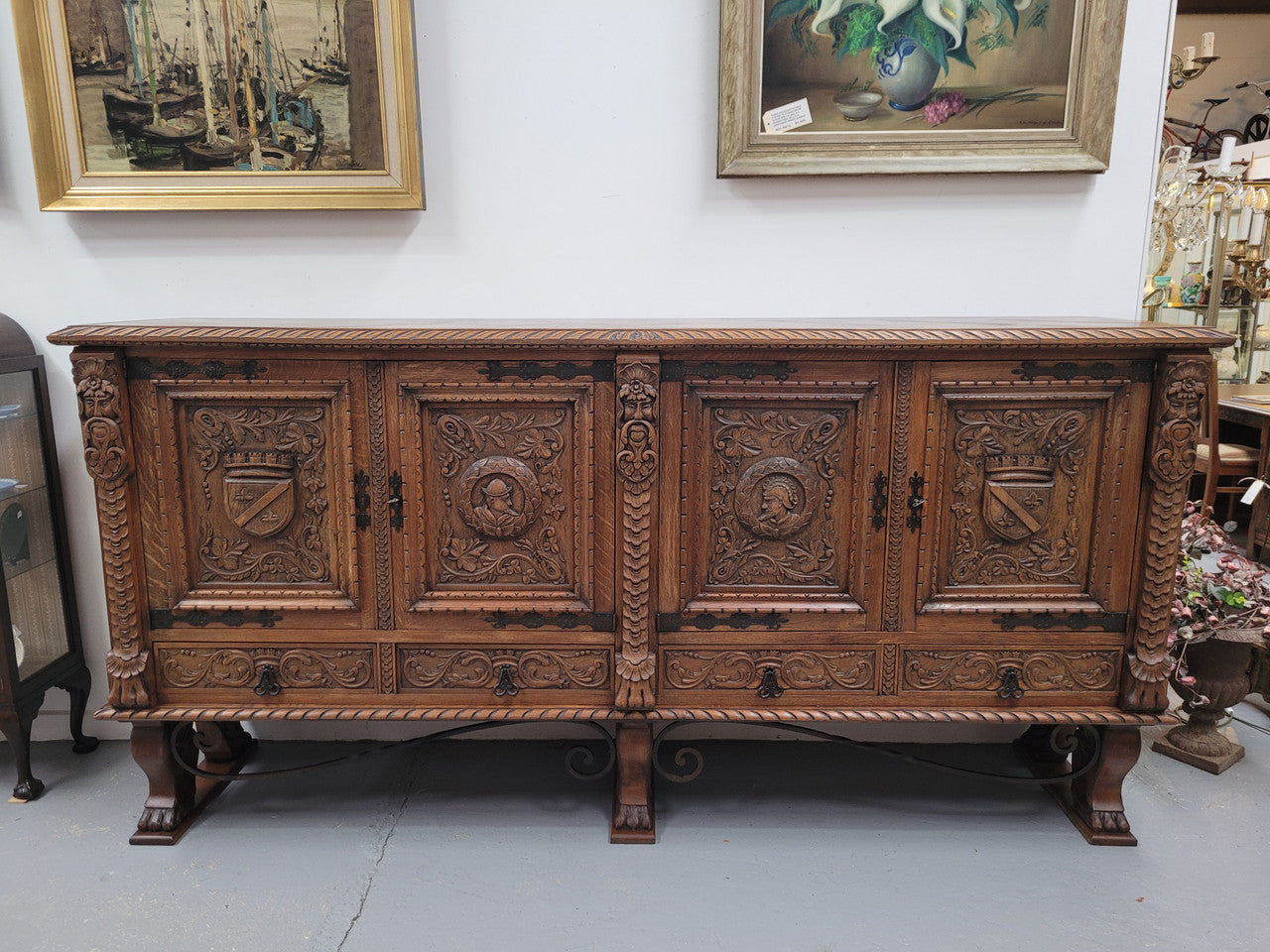 Large French Oak Renaissance style four door sideboard/buffet. Great decorative item with amazing carvings and stunning iron work on base. It is in good original detailed condition. Can pull apart completely making it easier to move.