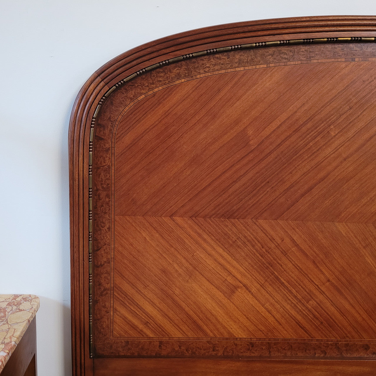 This elegant French Art Deco Walnut & Burr Walnut queen-size bed showcases stunning bronze mounts and impeccable craftsmanship. Its custom-made slats ensure a comfortable and supportive rest, while the ease of assembly and disassembly adds to its practicality. Sourced directly from France, it has been detailed and is in good condition.