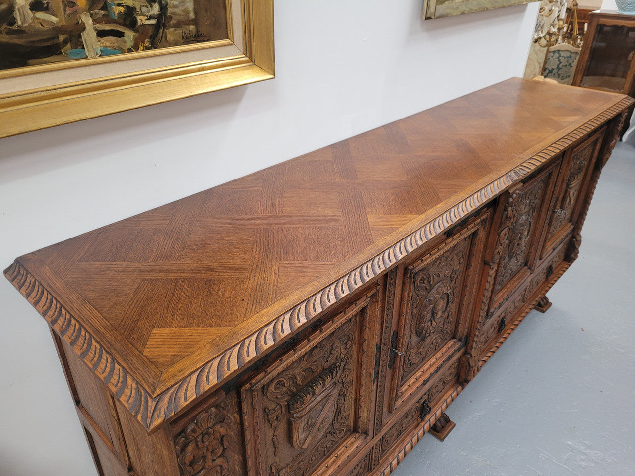 Large French Oak Renaissance style four door sideboard/buffet. Great decorative item with amazing carvings and stunning iron work on base. It is in good original detailed condition. Can pull apart completely making it easier to move.